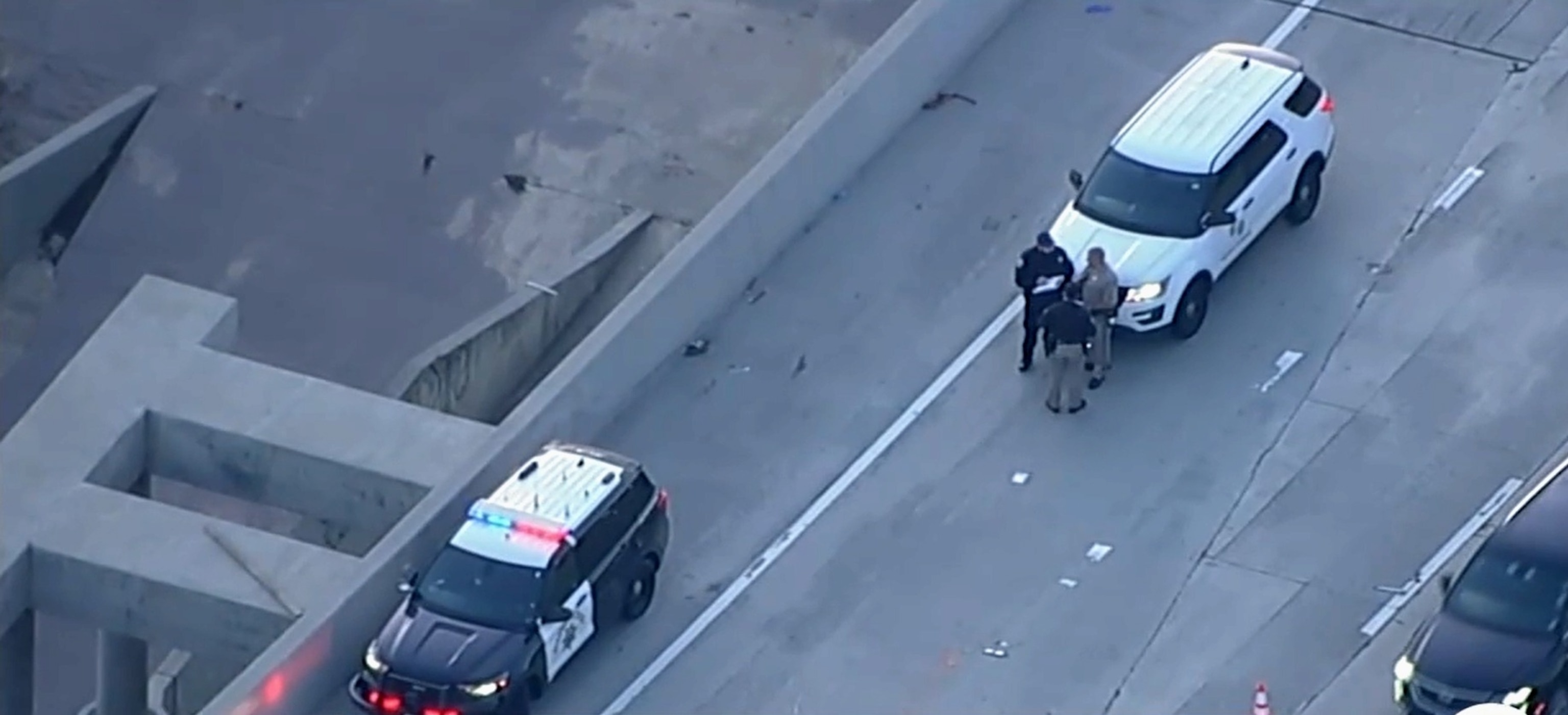 PHOTO: In this screen grab from a video, law enforcement officers are shown on an LA highway after finding a body, on April 8, 2024. 