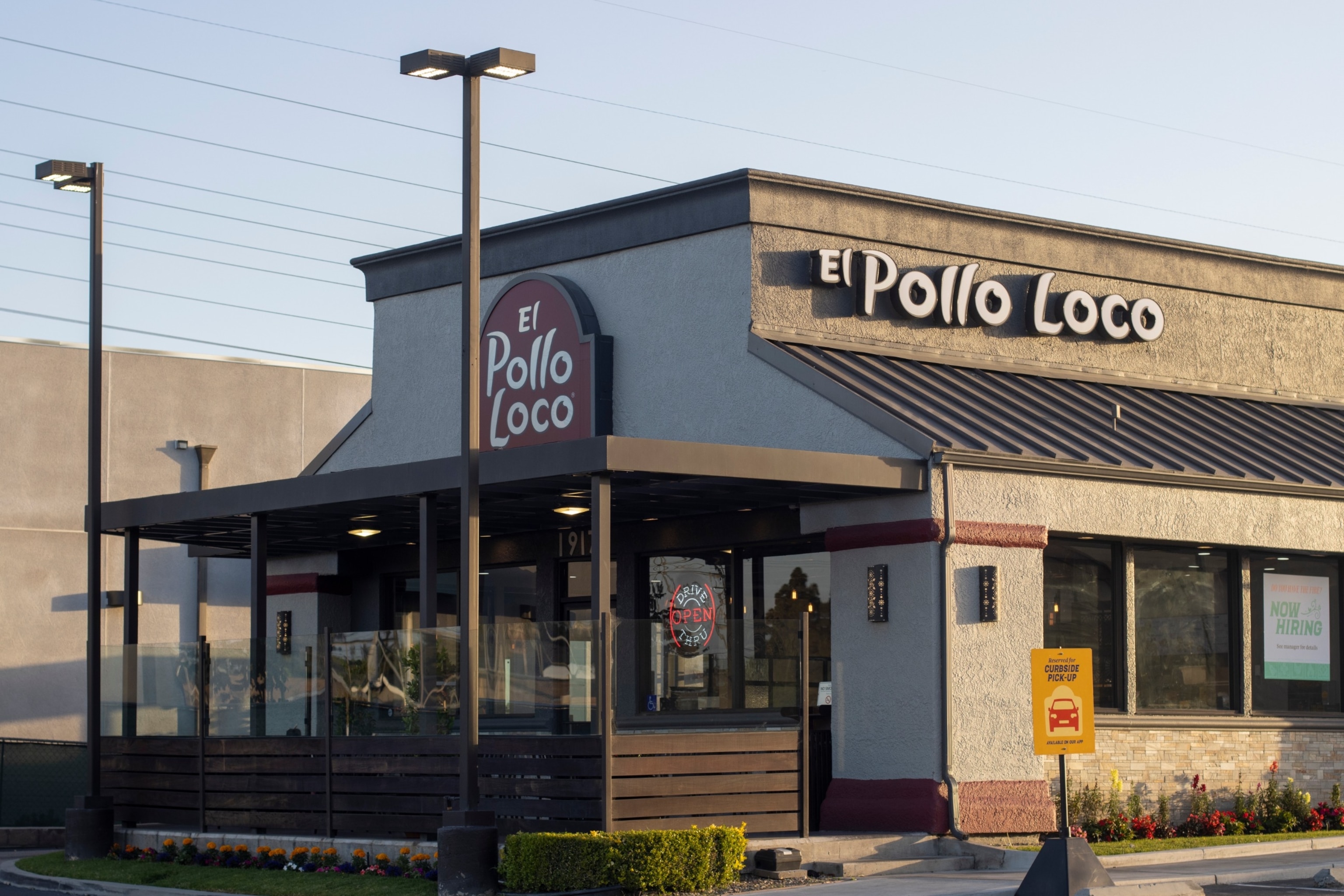 PHOTO: Exterior view of an El Pollo Loco restaurant in Huntington Beach, Calif., at dusk, on May 8, 2022.