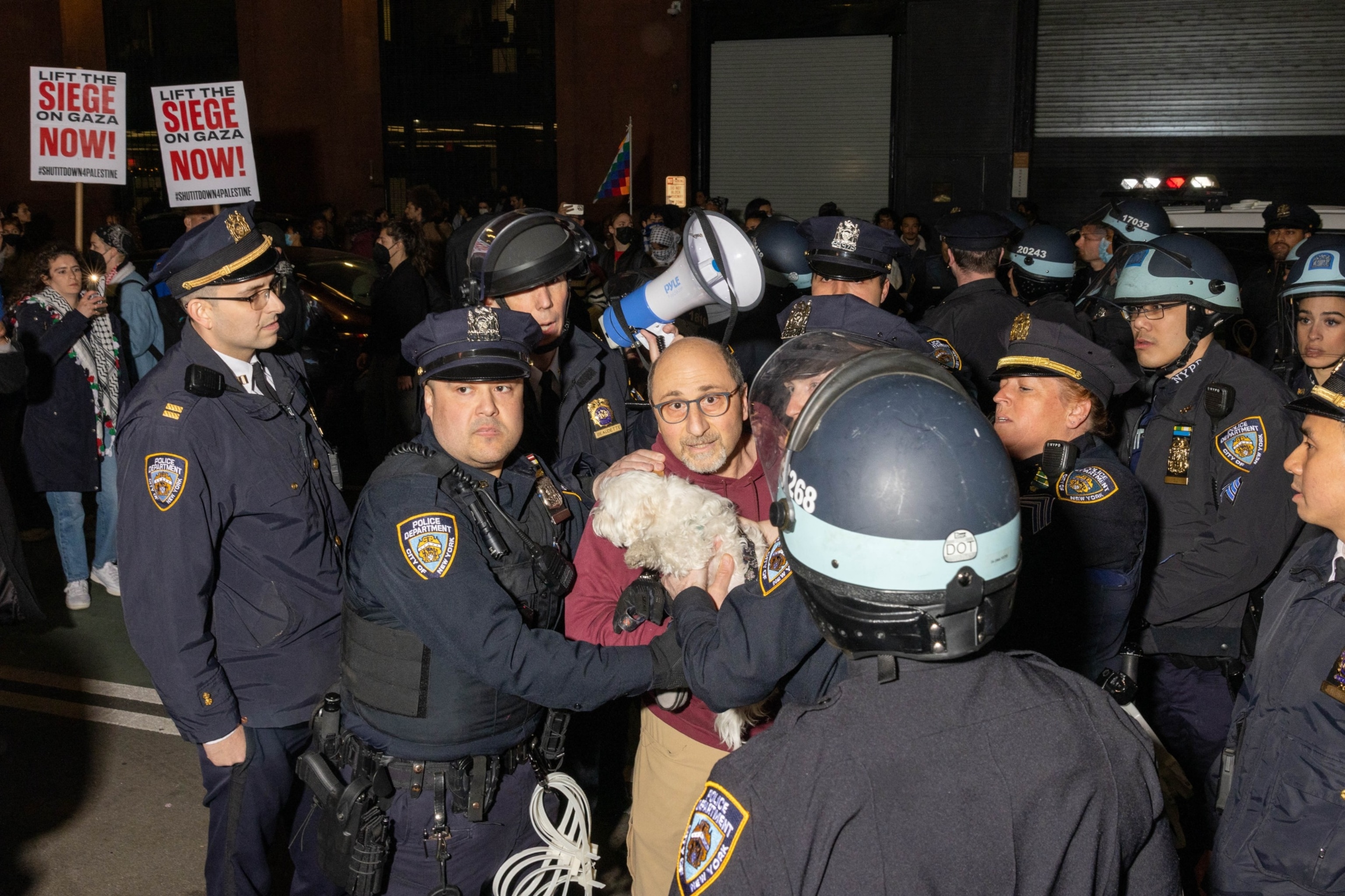 PHOTO: NYPD officers detain pro-Palestinian students and protesters who had set up an encampment on the campus of New York University (NYU) to protest the Israel-Hamas war, in New York on April 22, 2024. 