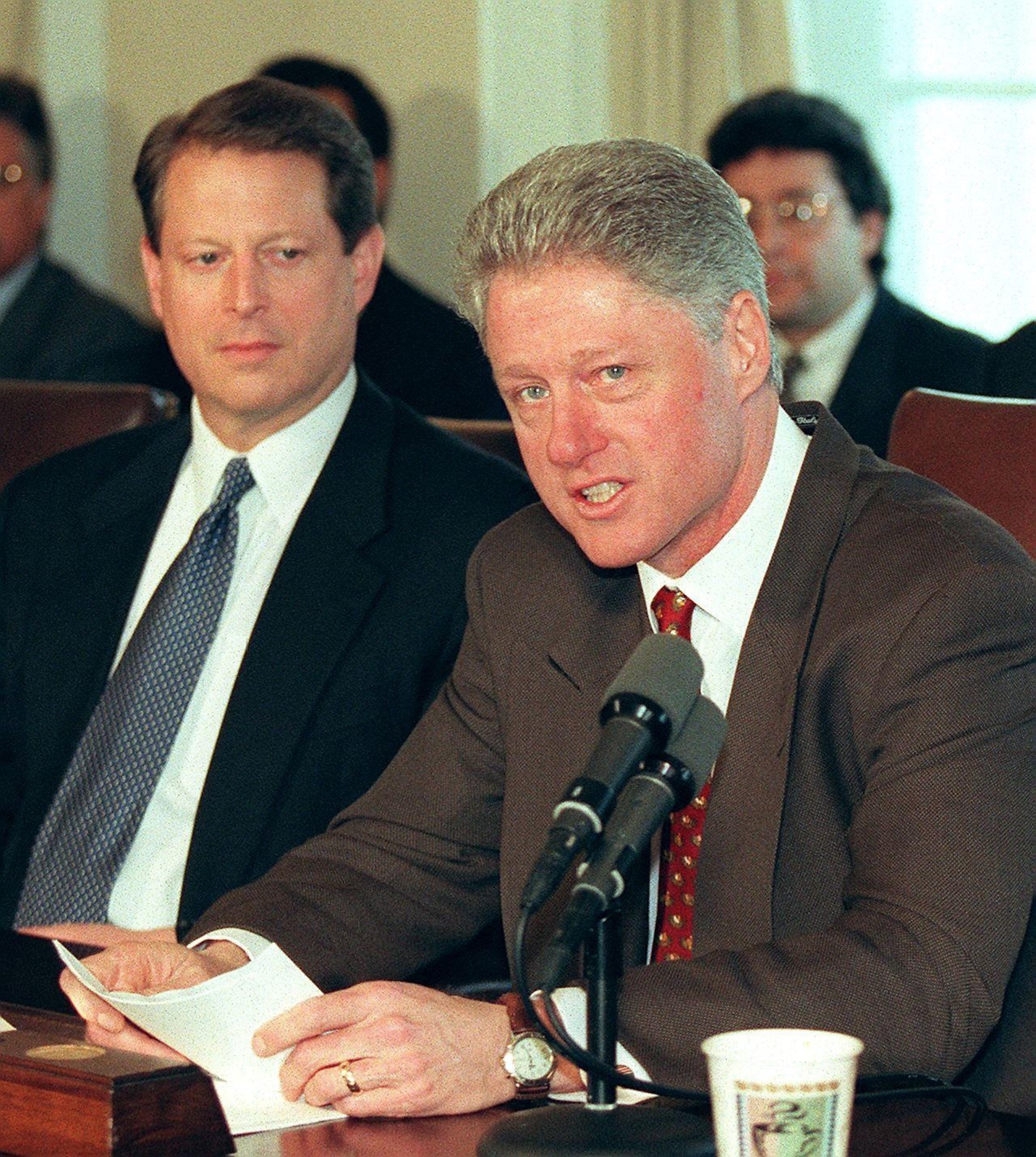 PHOTO: President Bill Clinton speaks to reporters as Vice President Al Gore looks on before the start of meetings at the White House 05 March in Washington, DC.