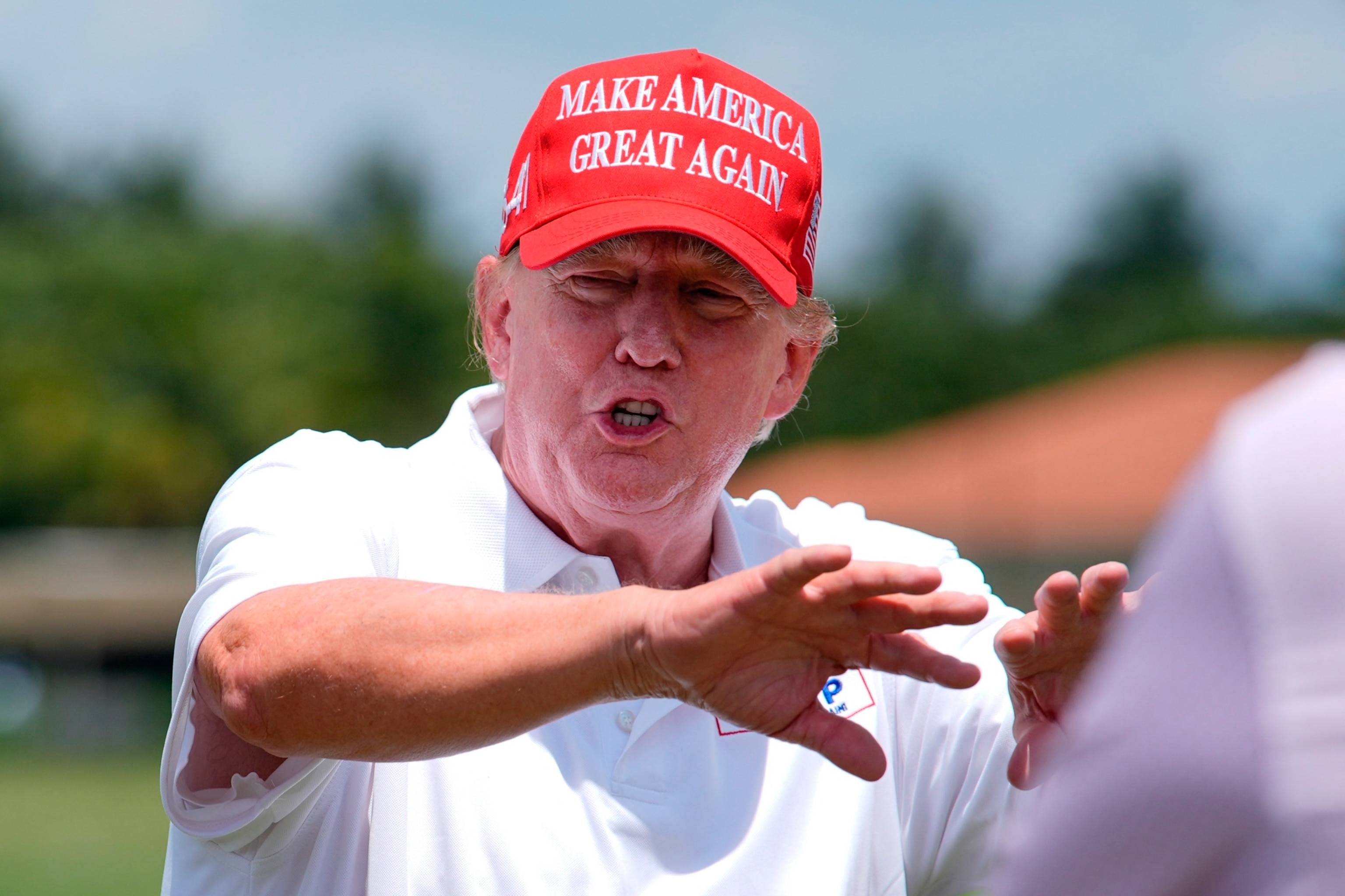 PHOTO: Republican presidential candidate former President Donald Trump gestures as he visits the driving range ahead of the final round of LIV Golf Miami, at Trump National Doral Golf Club, Sunday, April 7, 2024, in Doral, Fla.