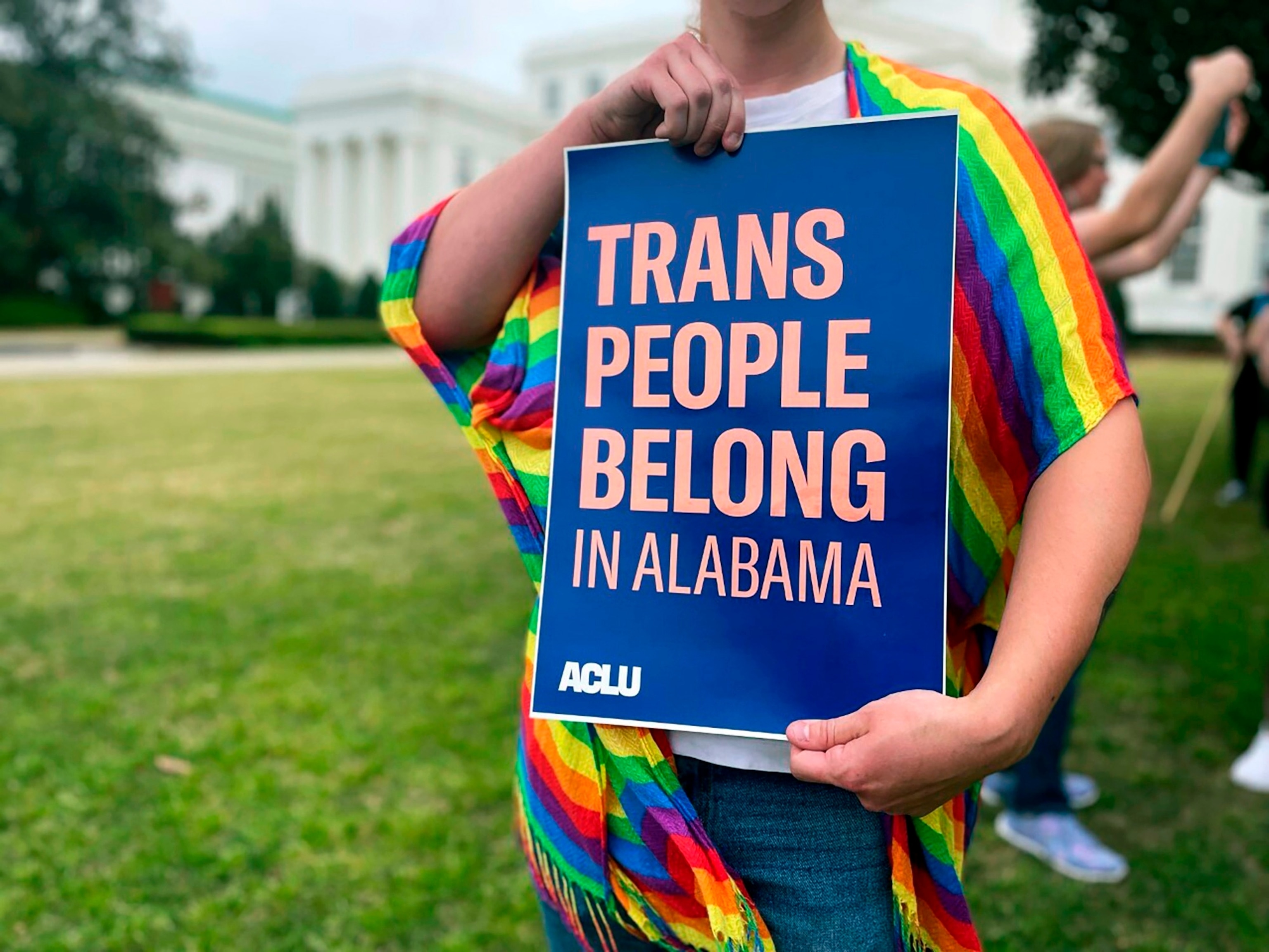 PHOTO: A person holds up a sign reading, "Trans People Belong in Alabama," during a rally outside the Alabama Statehouse in Montgomery, Ala., on International Transgender Day of Visibility, March 31, 2023. 