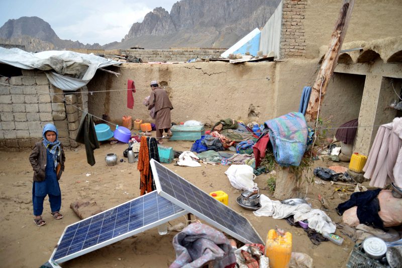 An Afghan man collects his belongings inside the courtyard of his damaged house following heavy rains and flash flooding, in Kandahar on April 14, 2024. At least 33 people have been killed over three days of heavy rains and flash flooding in Afghanistan, the government's disaster management department said on April 14. (Photo by Sanaullah SEIAM / AFP) (Photo by SANAULLAH SEIAM/AFP via Getty Images)