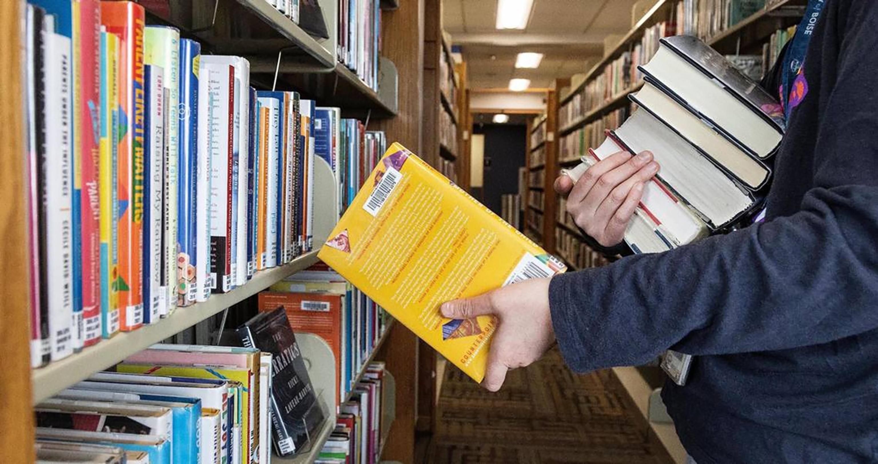 PHOTO: A librarian returns books to the shelves at a Boise Public Library branch in Boise, ID, Feb. 28, 2023. 