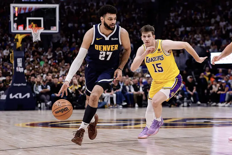 Denver Nuggets guard Jamal Murray (27) controls the ball ahead of Los Angeles Lakers guard Austin Reaves (15) in the third quarter during game five of the first round for the 2024 NBA playoffs at Ball Arena. Mandatory Credit: Isaiah J. Downing-USA TODAY Sports