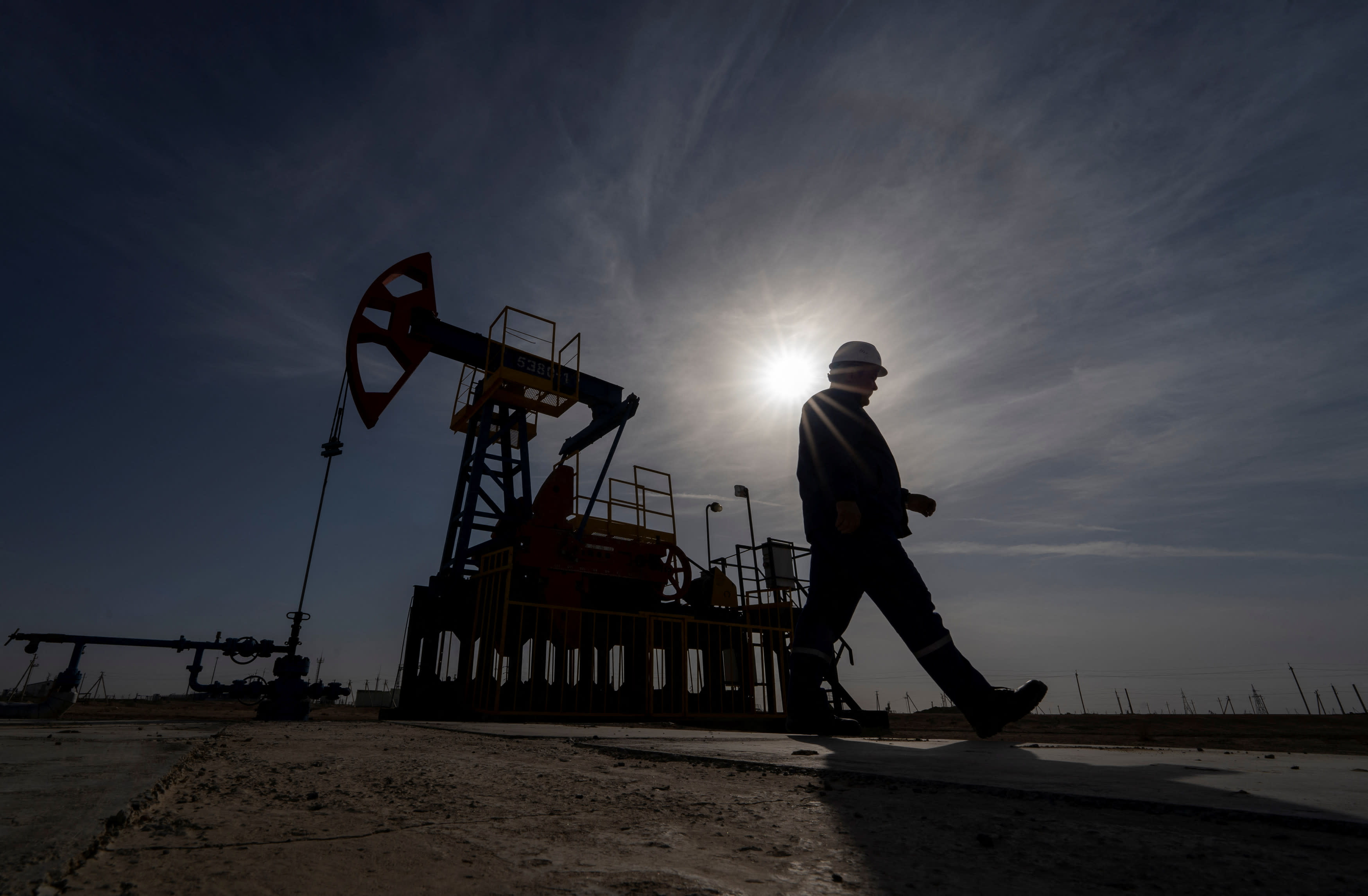 An oil and gas industry worker walks during operations of a drilling rig at Zhetybay field in the Mangystau region, Kazakhstan, November 13, 2023. 