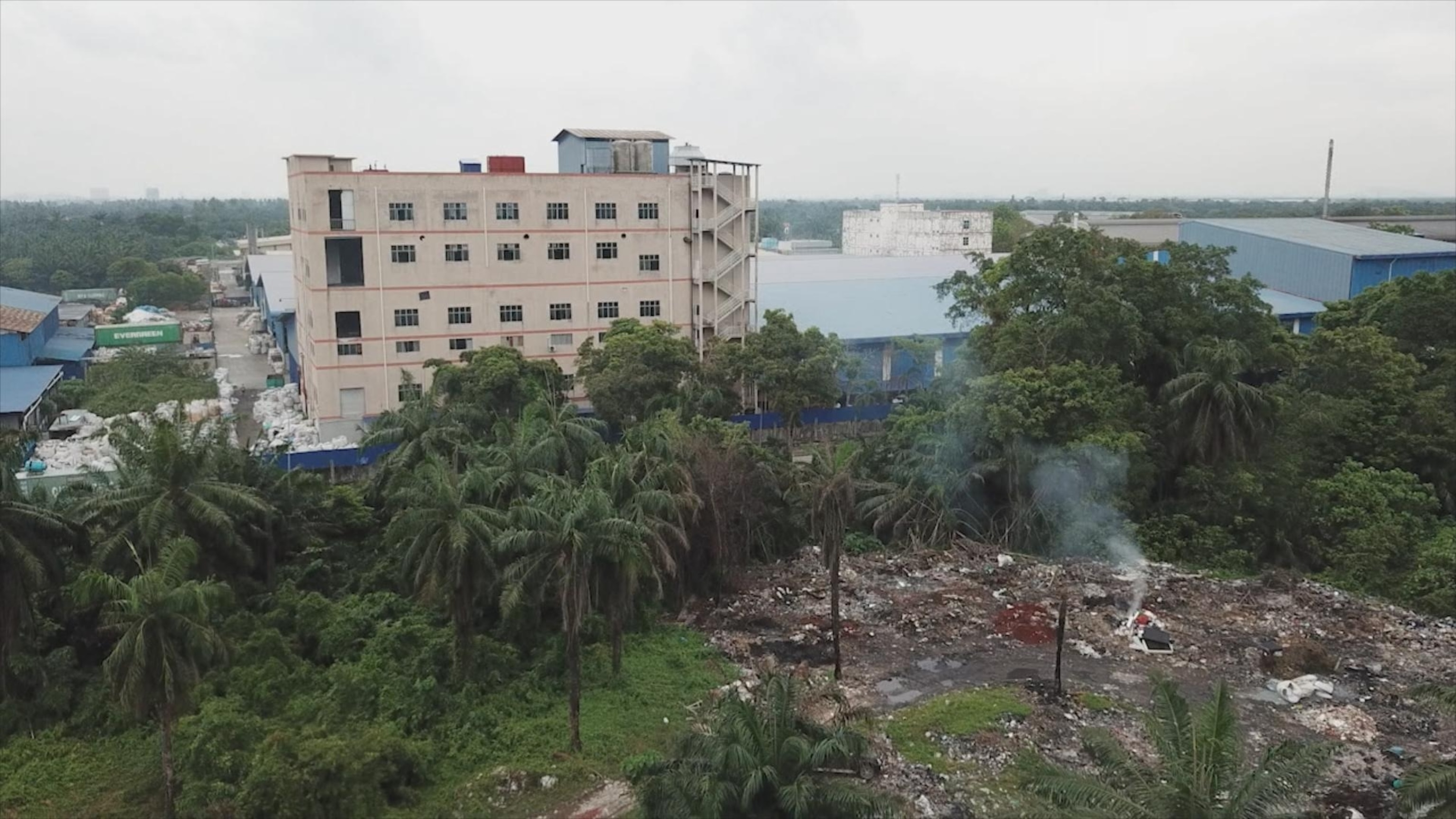 PHOTO: A burning dumpsite located directly beside a plastic manufacturing facility outside Jenjarom, Malaysia.