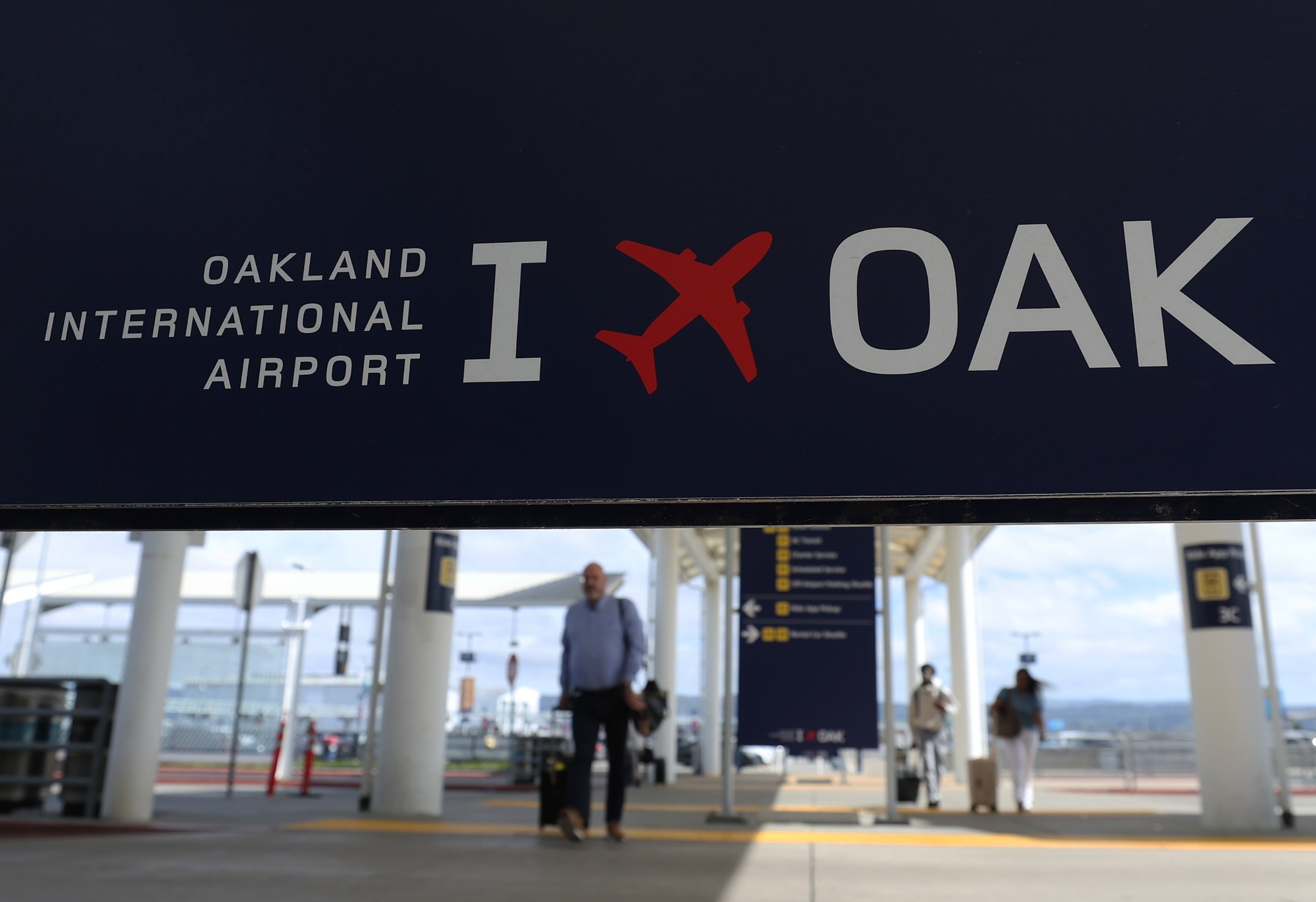 PHOTO: Travelers walk towards Terminal 2 at Oakland International Airport on April 12, 2024 in Oakland, Calif.