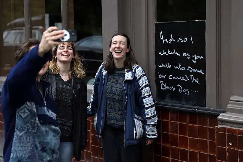 Fans of Taylor Swift take images next to lyrics from the song The Black Dog by Taylor Swift, written outside The Black Dog pub, believed by its owners to have been referenced in the track, in London, Britain, April 22, 2024. REUTERS/Toby Melville