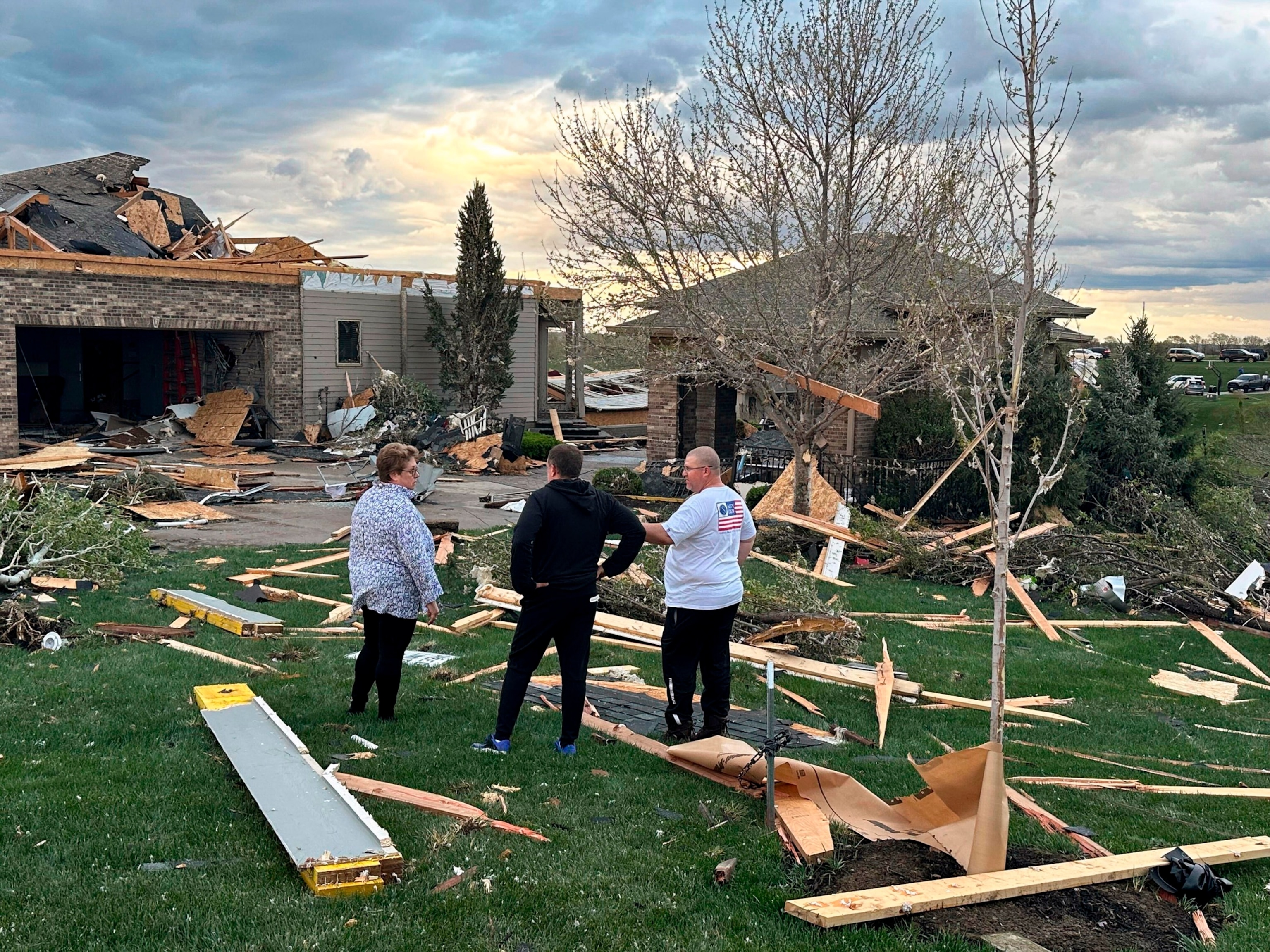 PHOTO: Homeowners assess damage after a tornado caused extensive damage in their neighborhood northwest of Omaha, in Bennington, Neb., on April 26, 2024.