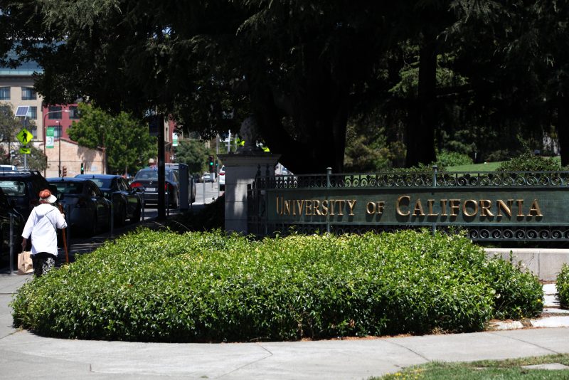 BERKELEY, CALIFORNIA - JULY 22: A pedestrian walks by a sign in front of the U.C. Berkeley campus on July 22, 2020 in Berkeley, California. U.C. Berkeley announced plans on Tuesday to move to online education for the start of the school's fall semester due to the coronavirus COVID-19 pandemic. (Photo by Justin Sullivan/Getty Images)