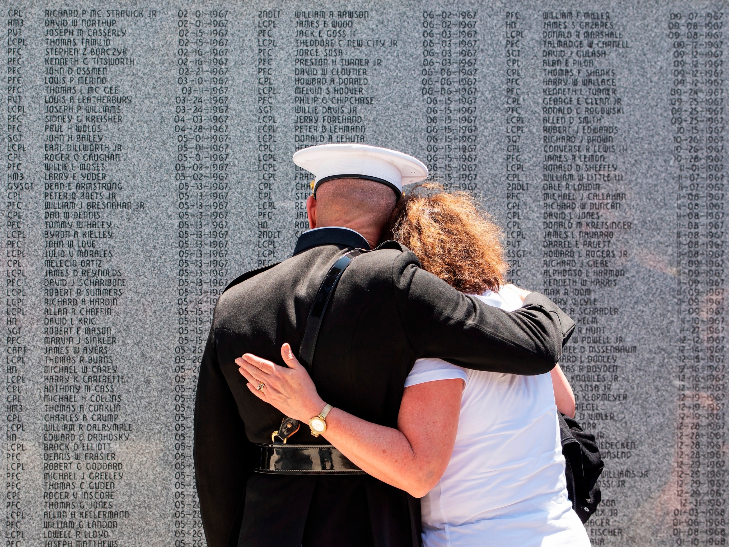 PHOTO: USMC Maj. Gen. Eric Smith, left, comforts Gold Star family member Yvonne Darragh in front of the newly unveiled 5th Marines Vietnam Memorial at Camp Pendleton, May 28, 2018.