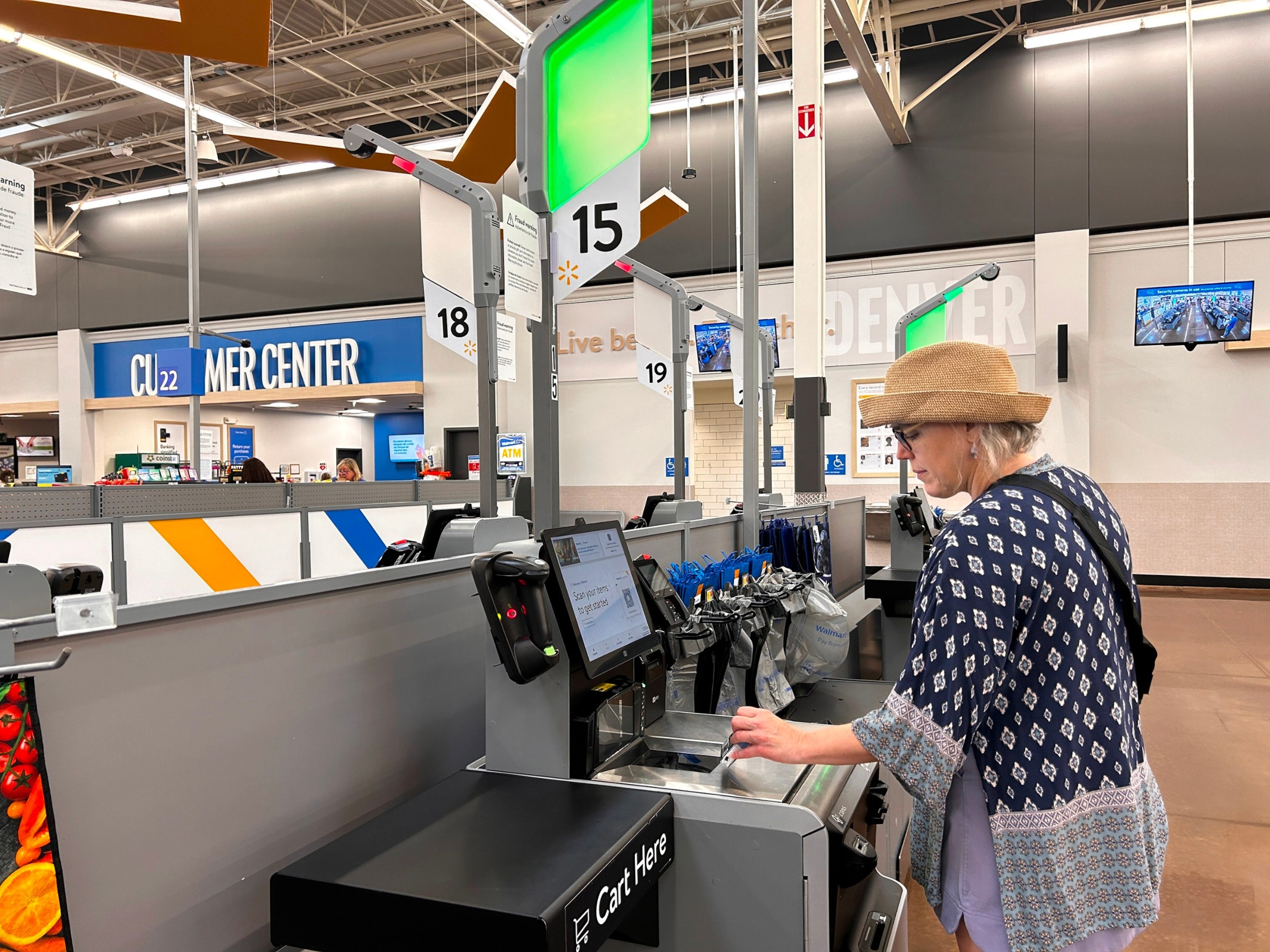 PHOTO: In this April 3, 2024, file photo, a woman scans items at self-service checkout at a Walmart megastore in North Carolina. 