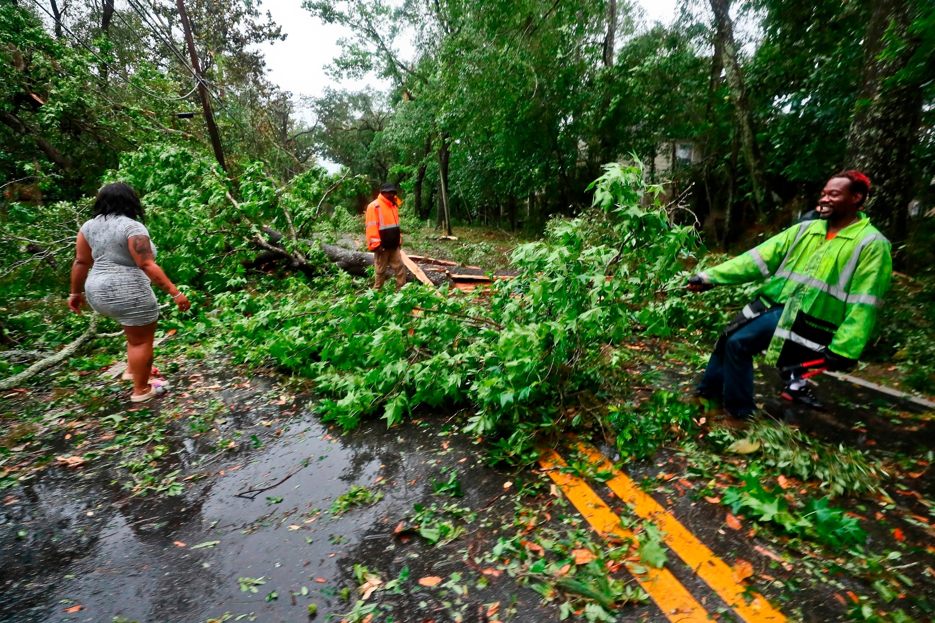 PHOTO: Residents of an apartment complex try to clear Old St. Augustine Road of trees and debris in Tallahassee, Fla., May 10, 2024. 
