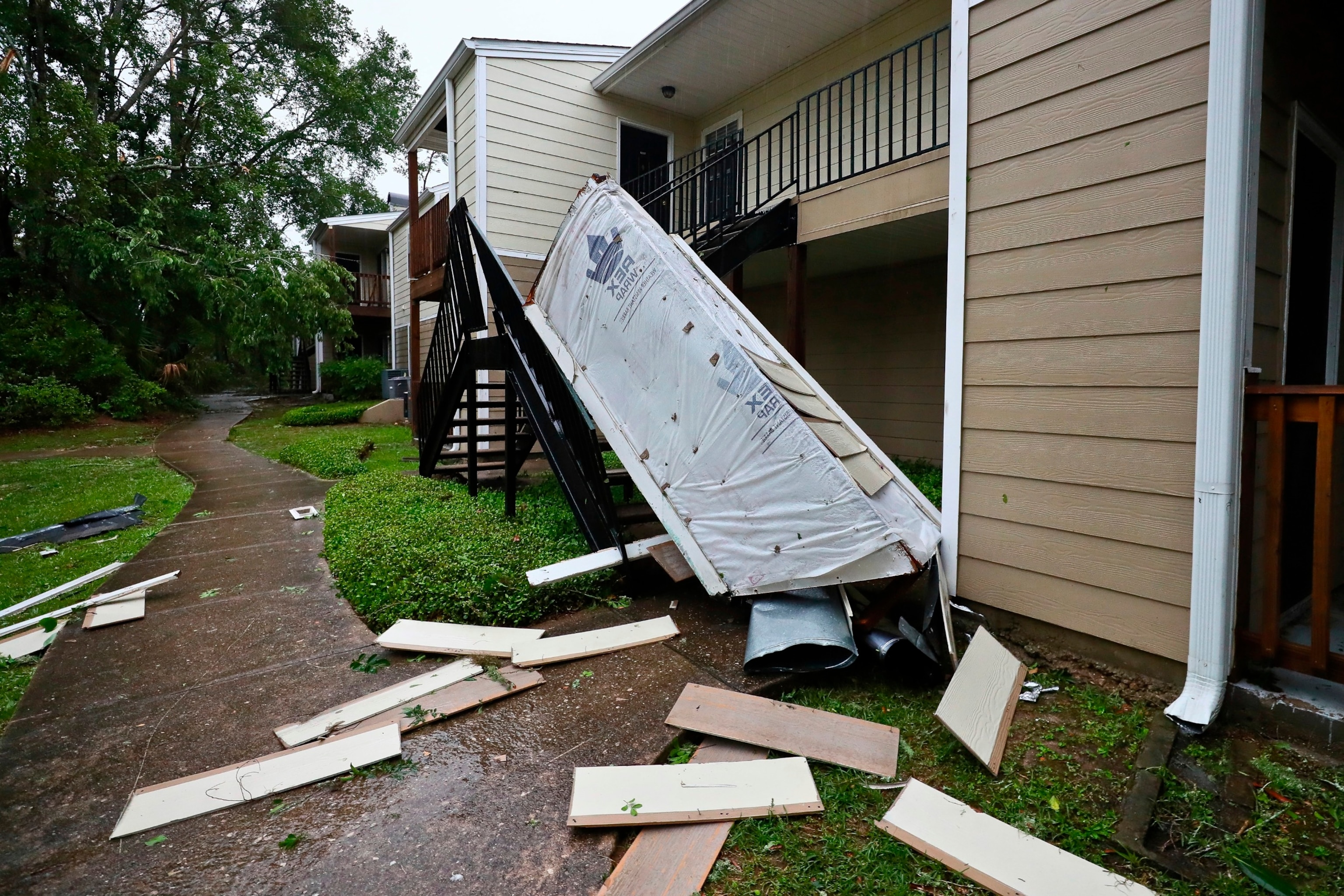 PHOTO: A chimney and siding, blown off a roof by extreme winds, rests in a stairwell at an apartment complex in Tallahassee, Fla., May 10, 2024. 