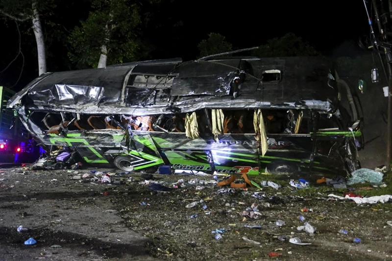 1 of 3 | The wreckage of a bus lies on the side of a road following an accident in Subang, West Java, Indonesia, late Saturday, May 11, 2024. The bus carrying high school students and teachers returning from an outing smashed into cars and motorbikes in Indonesia's West Java province, killing a number of people on board. (AP Photo/Ryan Suherlan)