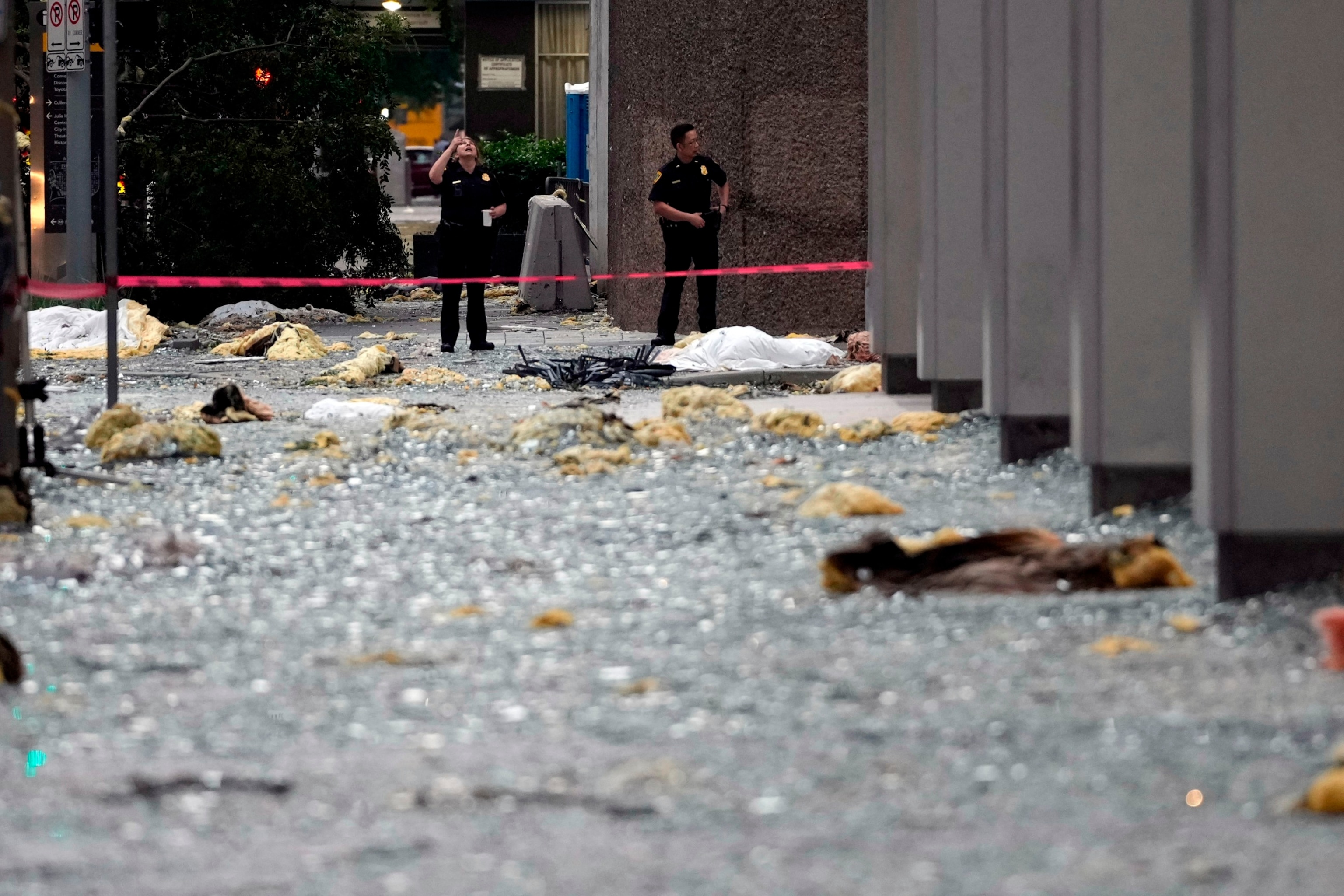 PHOTO: Houston Police Officers survey the damage near their downtown office in the aftermath of a severe thunderstorm, May 17, 2024, in Houston.