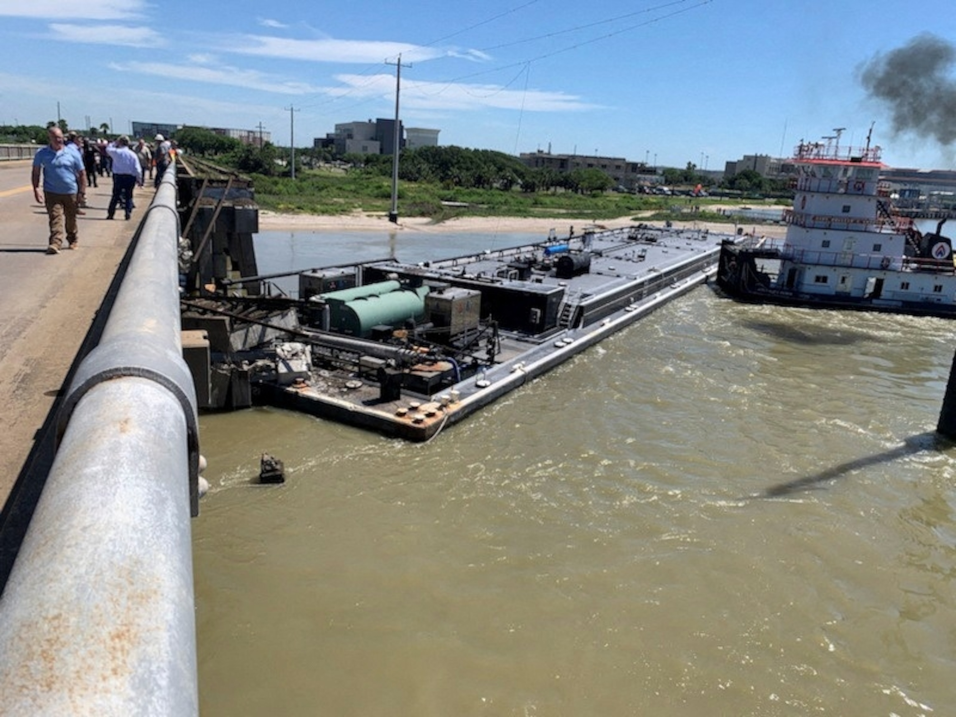 PHOTO: A barge that crashed into a bridge, forcing the closure of a roadway, is seen in Galveston, Texas, May 15, 2024 in this handout photo.