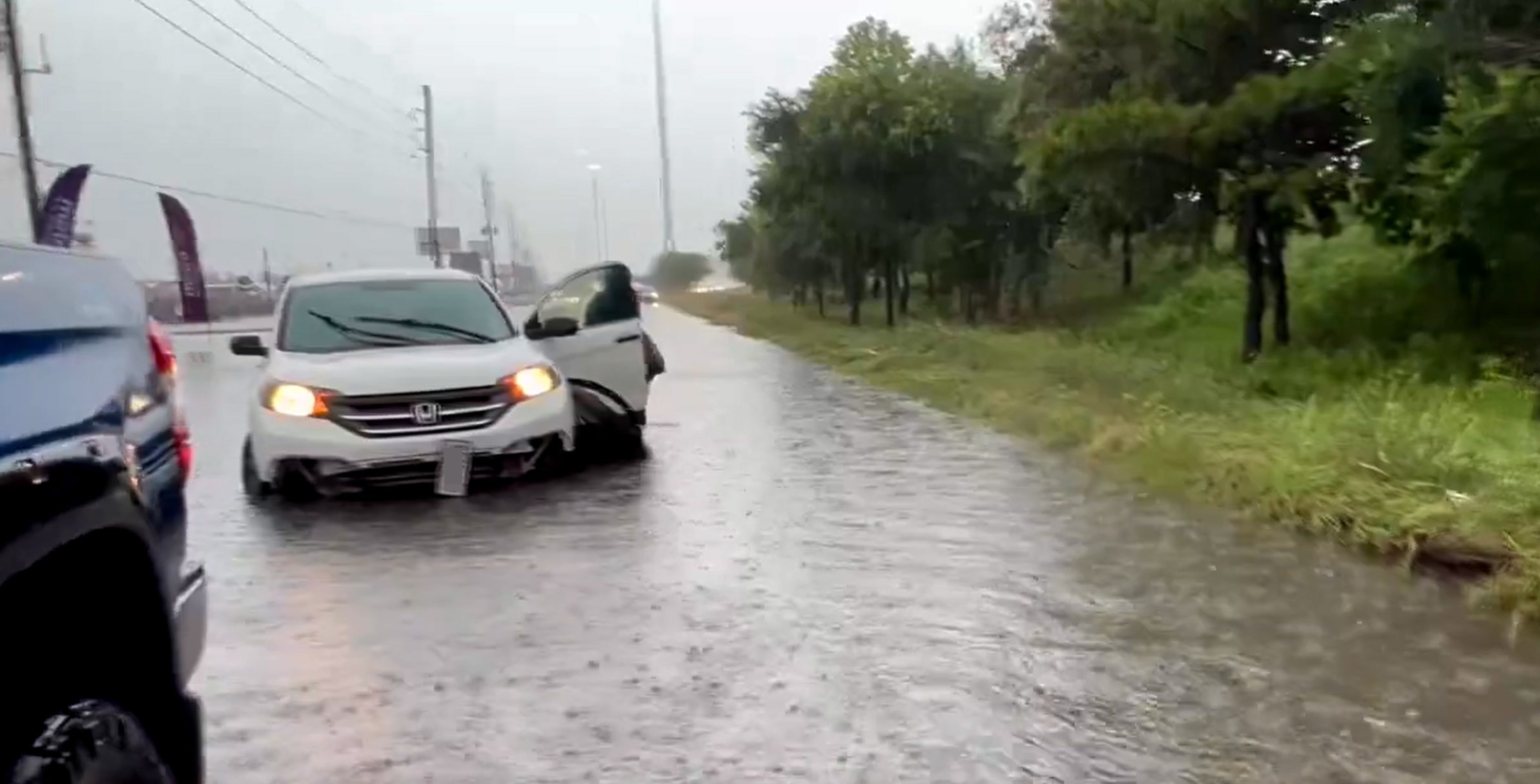 PHOTO: In this screen grab from a video posted on social media, a stranded motorist exits their vehicle on a flooded road in the Houston, Texas, area, on May 2, 2024.