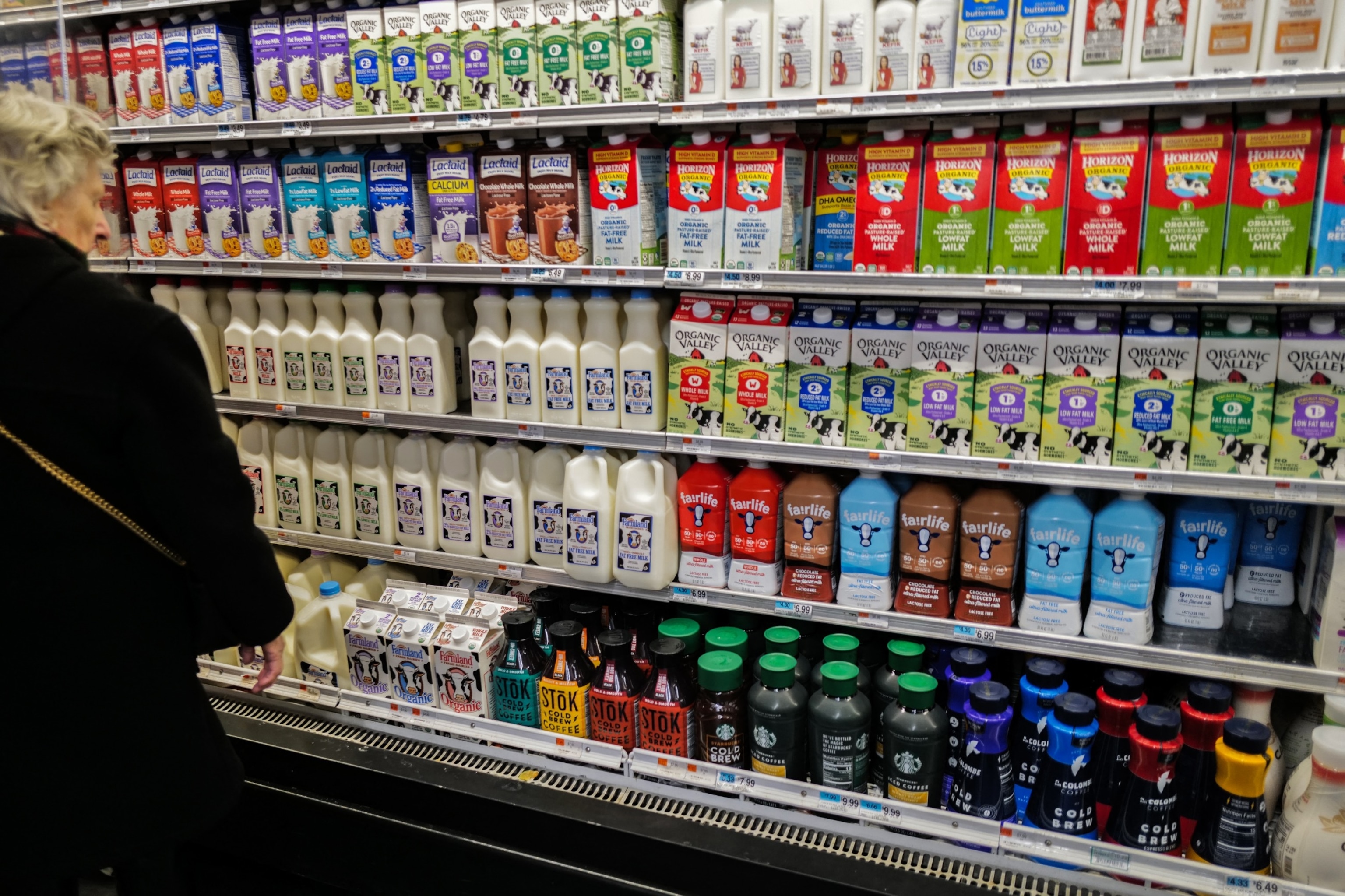 PHOTO: A woman shops in the dairy section of a supermarket in New York, Jan. 27, 2024. 