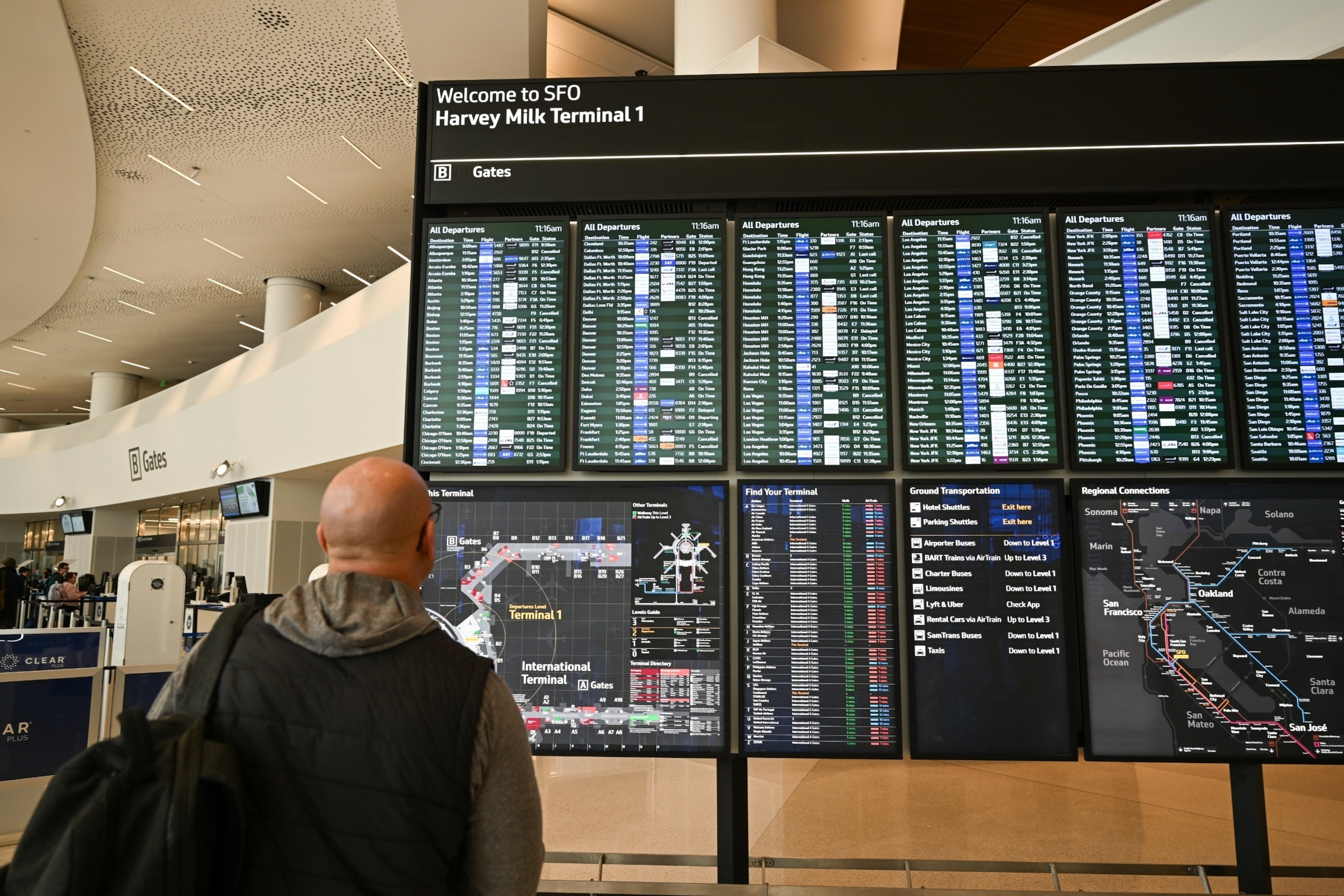 PHOTO: A man checks flight information signs at San Francisco International Airport (SFO) in San Francisco, CA, Feb. 4, 2024. 