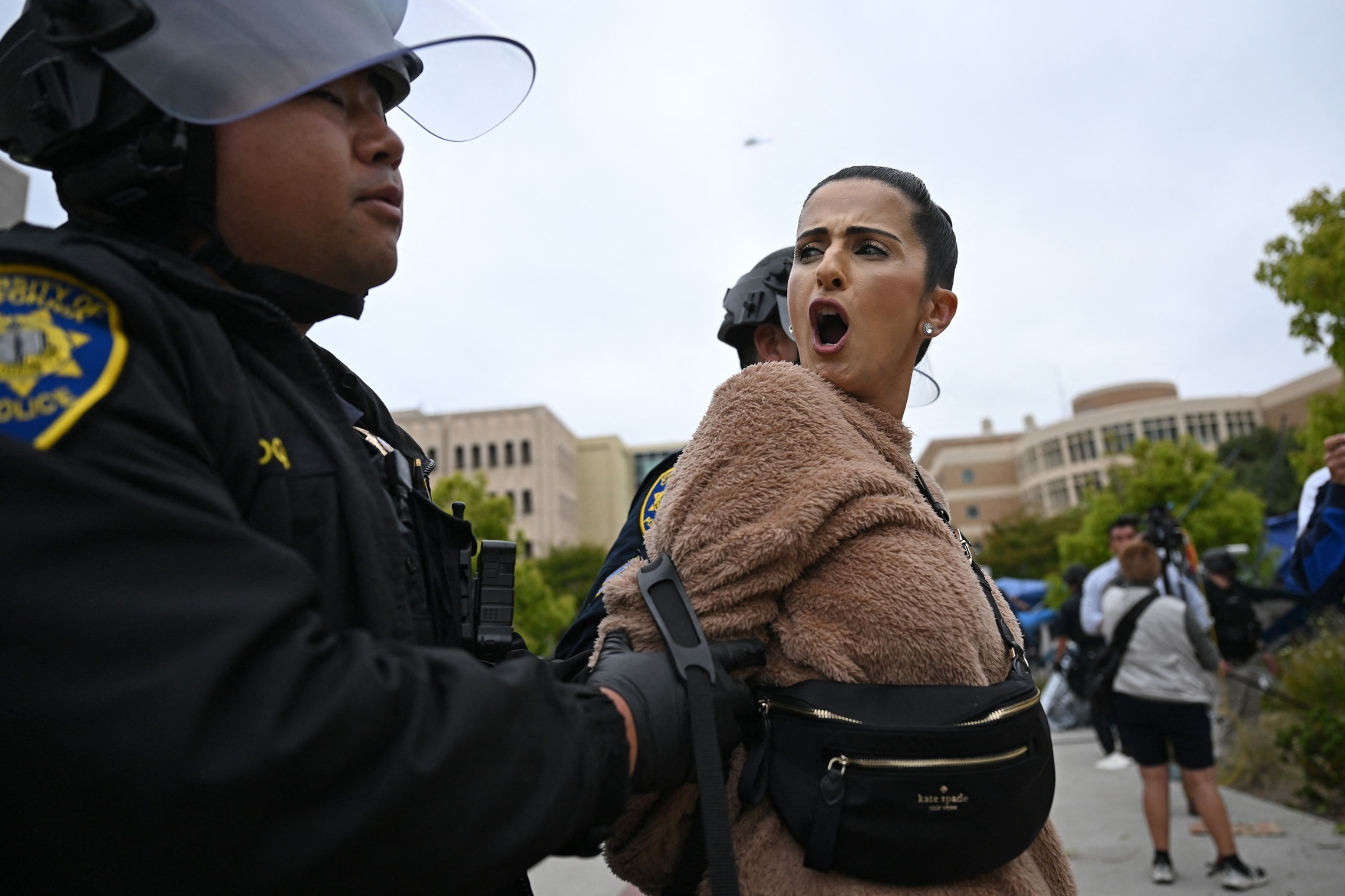 PHOTO: A pro-Palestinian demonstrator clash is arrested by police as an encampment is cleared after occupying and barricading the Physical Sciences Lecture Hall at the University of California, Irvine, in Irvine, Calif., on May 15, 2025. 