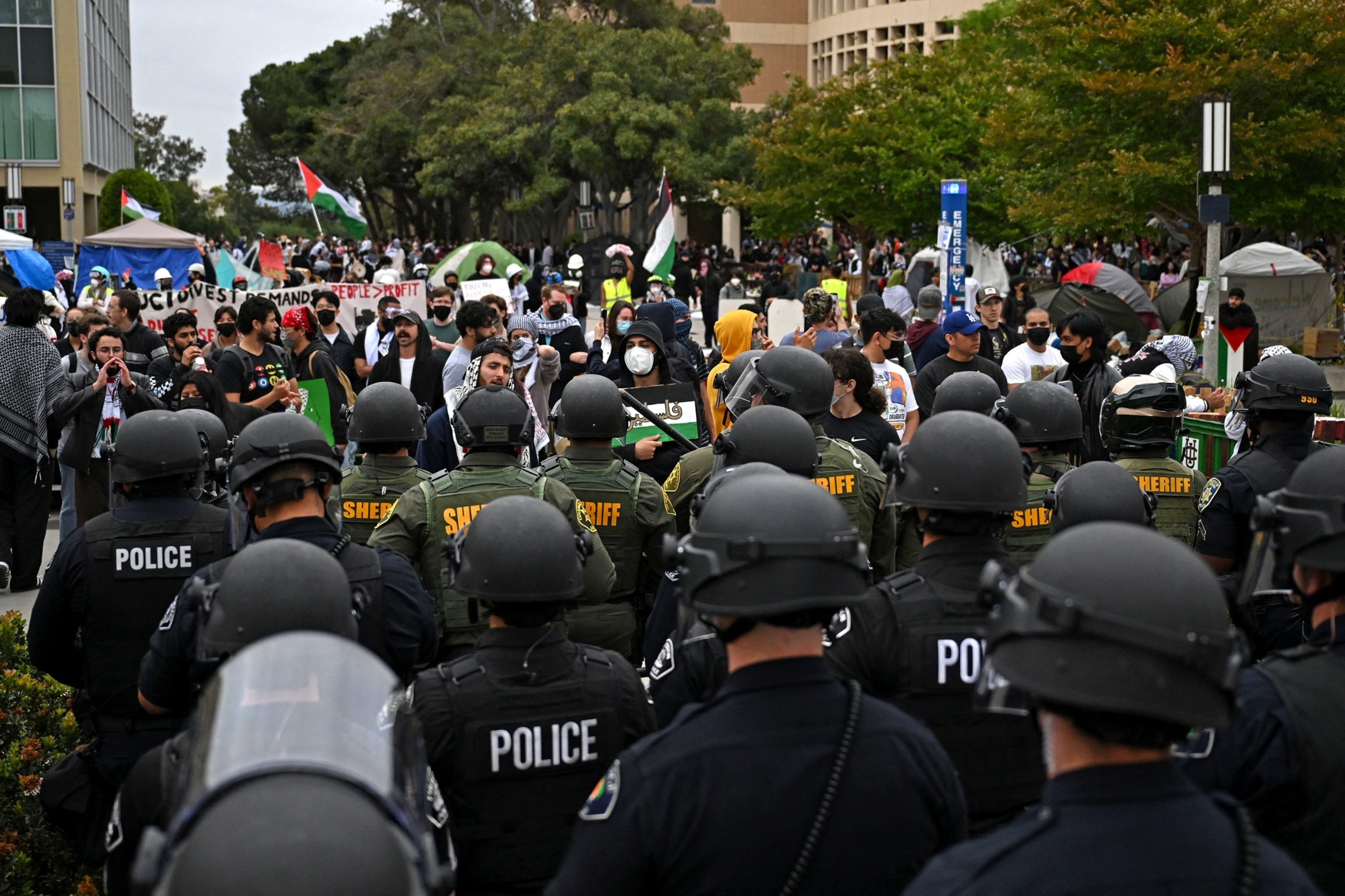 PHOTO: Pro-Palestinian demonstrators stand in front of a line of police as they clear an encampment after students occupied the Physical Sciences Lecture Hall at the University of California, Irvine, in Irvine, Calif., on May 15, 2025. 