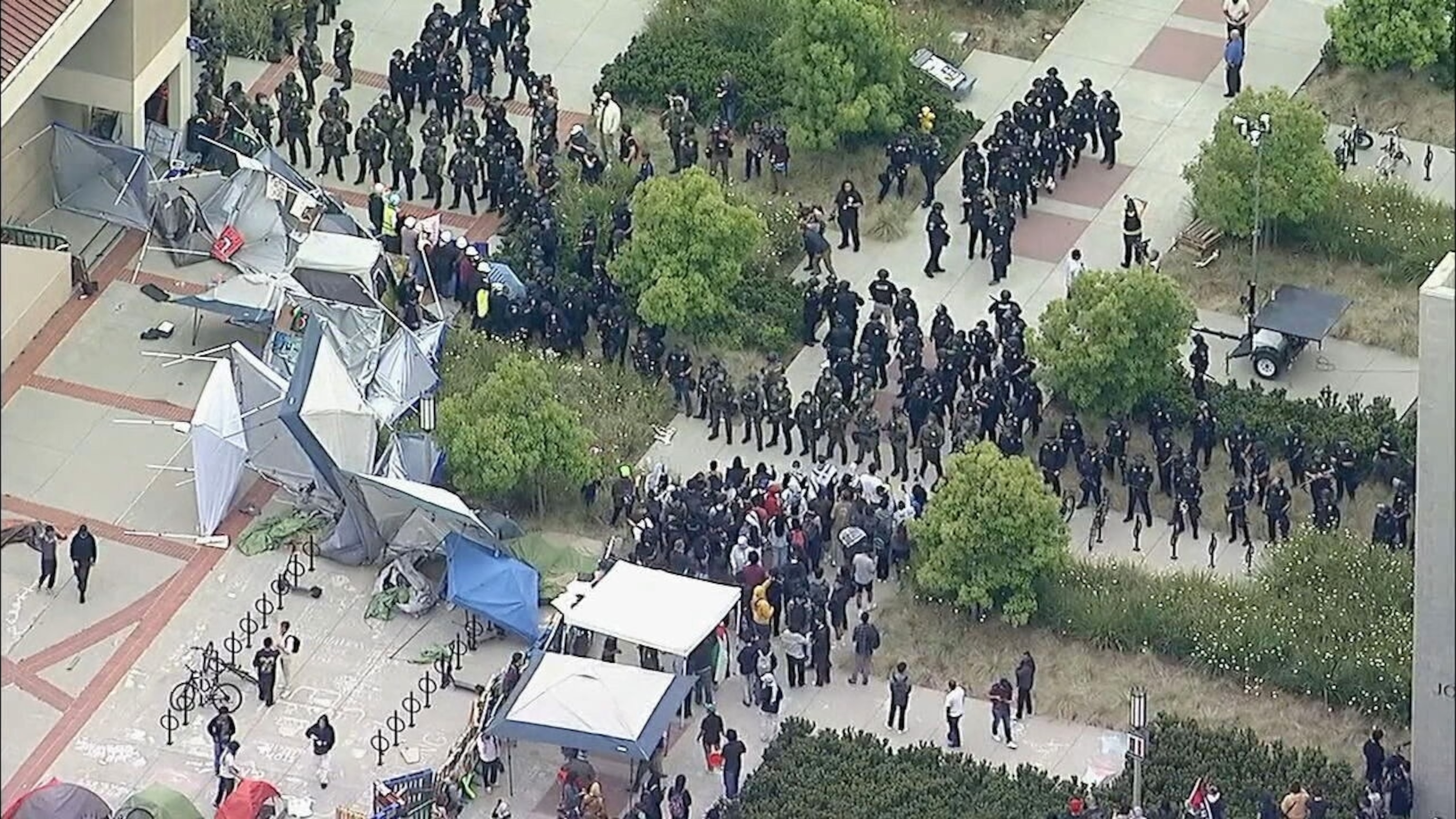 PHOTO: In this screen grab from a video, pro-Palestinian demonstrators stand in front of a line of police as they clear an encampment at the University of California, Irvine, in Irvine, Calif., on May 15, 2025. 