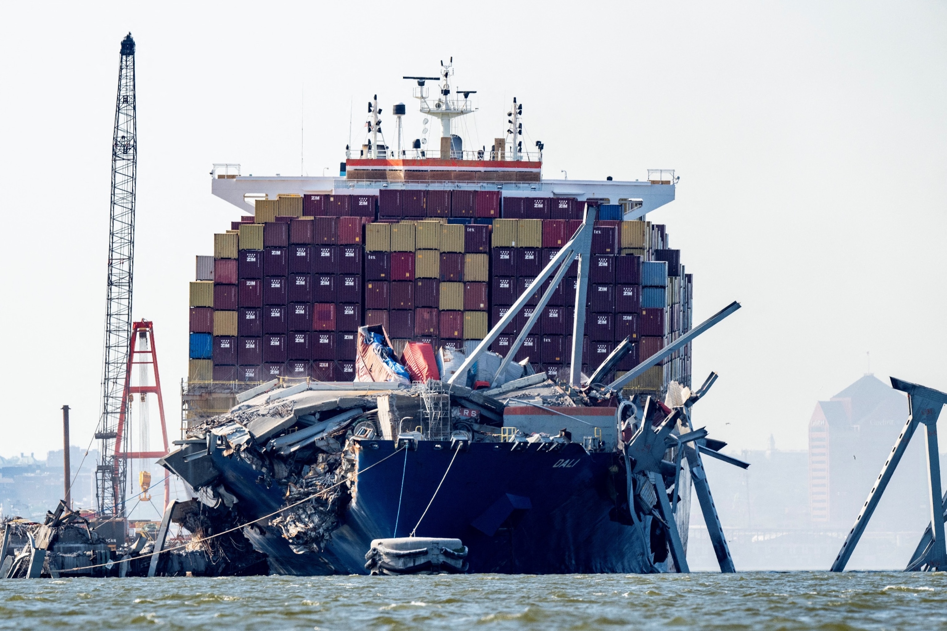 PHOTO: A section of the Francis Scott Key Bridge rests in the water next to the Dali container ship in Baltimore on May 13, 2024, after crews conducted a controlled demolition.