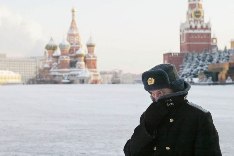 MOSCOW - JANUARY 7: A Russian police officer, braving the bitter cold, patrols Red Square with the Kremlin in the background January 7, 2003 in Moscow. Temperatures fell to 27 degrees below zero Celcius (17 below zero Fahrenheit) in Moscow. (Photo by Oleg Nikishin/Getty Images)