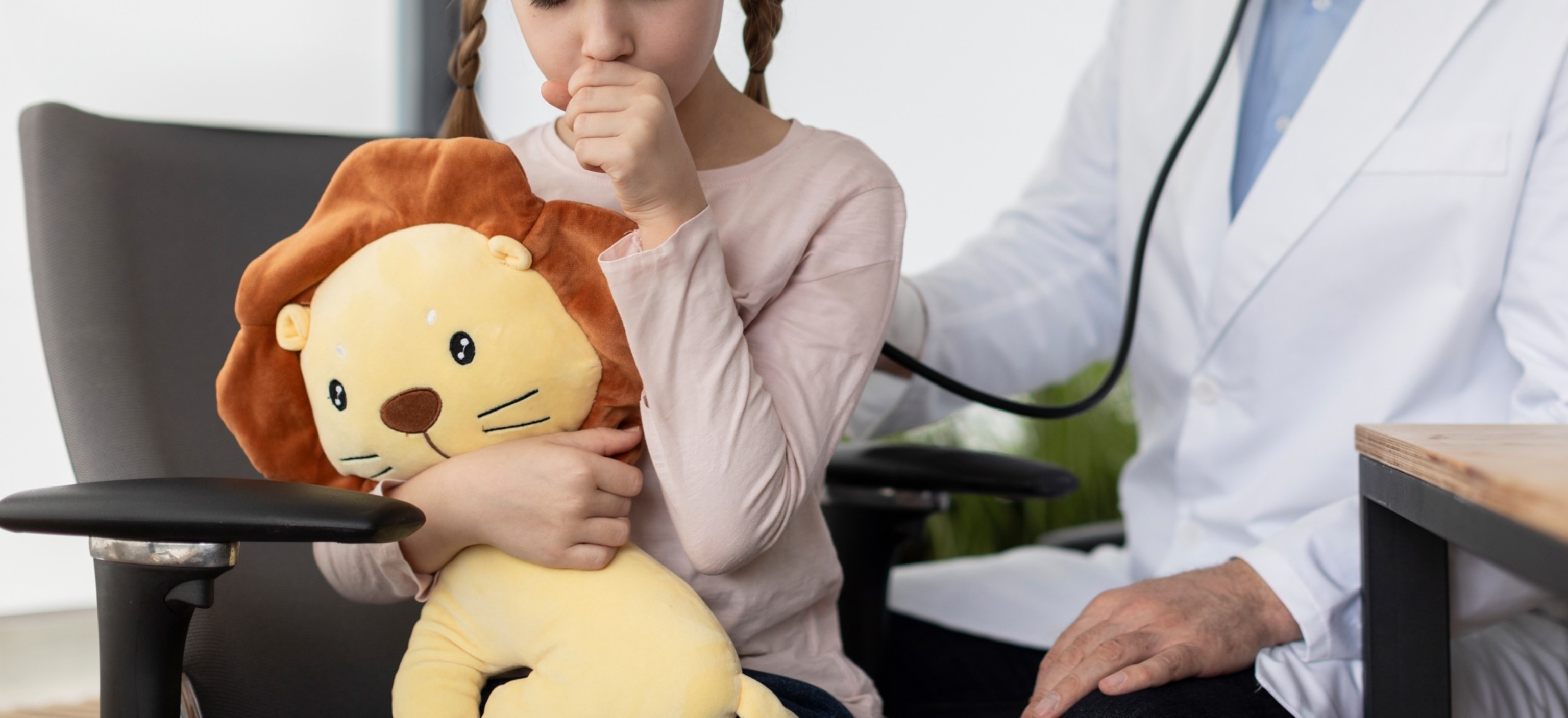 PHOTO: A pediatrician doctor examines a girl coughing in this undated stock photo.