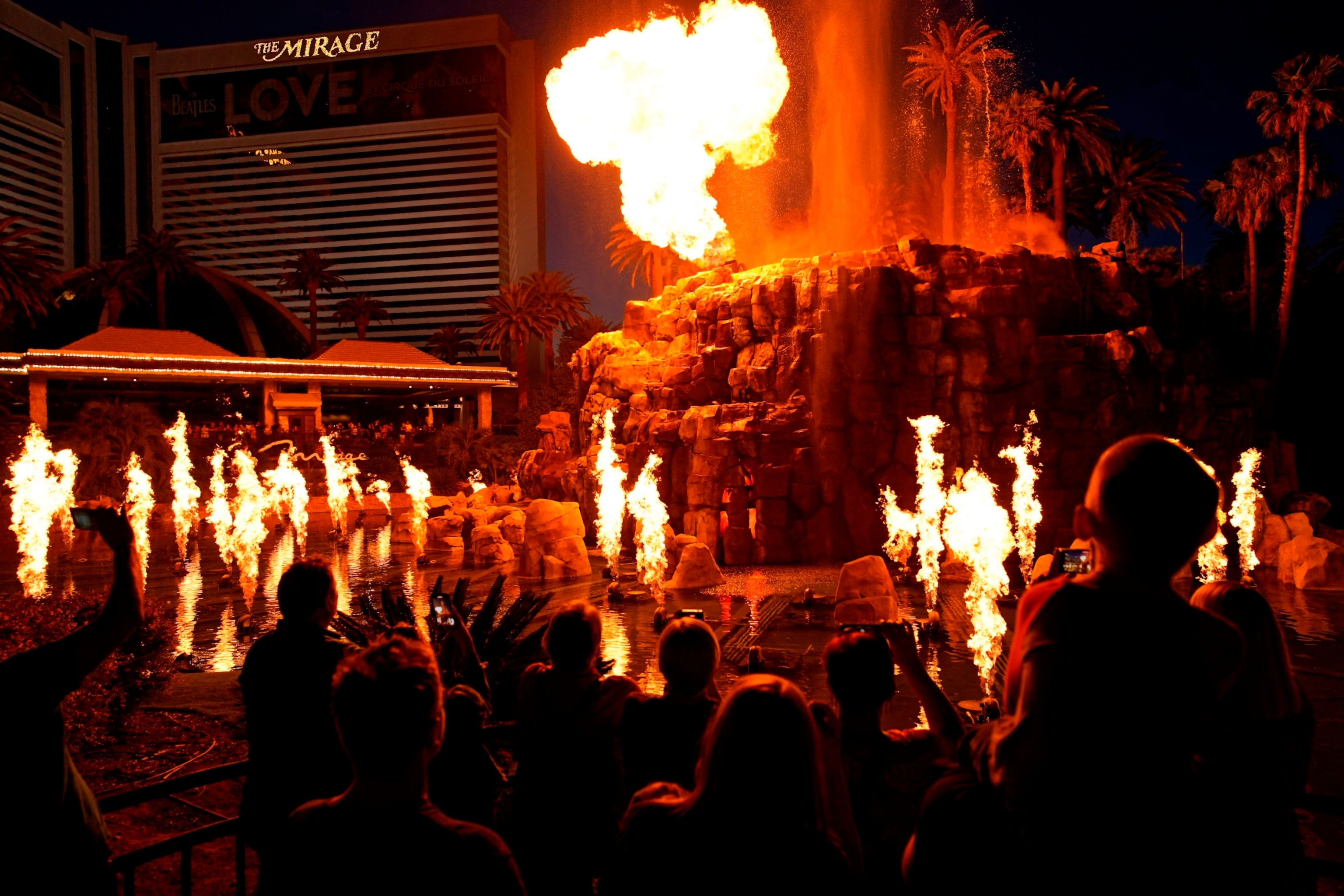 PHOTO: People watch the Volcano show at the Mirage hotel-casino along the Las Vegas Strip, May 13, 2022, in Las Vegas. 