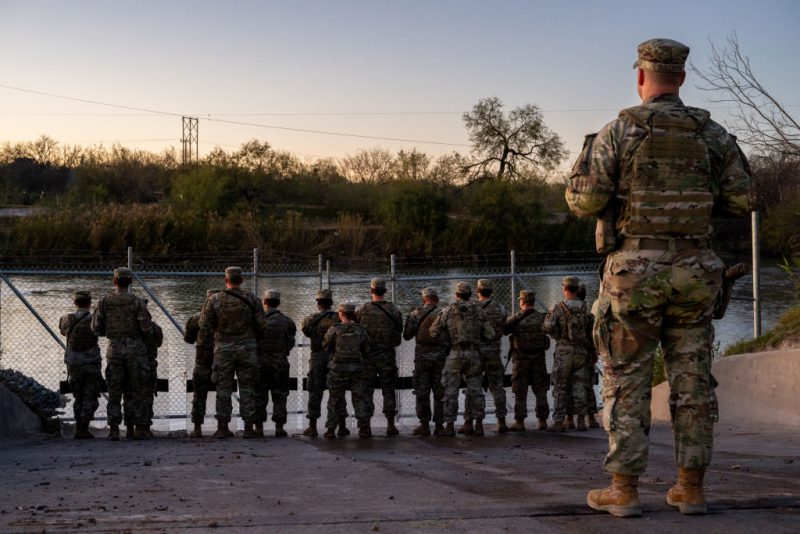 EAGLE PASS, TEXAS - JANUARY 12: National Guard soldiers stand guard on the banks of the Rio Grande river at Shelby Park on January 12, 2024 in Eagle Pass, Texas. The Texas National Guard continues its blockade and surveillance of Shelby Park in an effort to deter illegal immigration. The Department of Justice has accused the Texas National Guard of blocking Border Patrol agents from carrying out their duties along the river. (Photo by Brandon Bell/Getty Images)