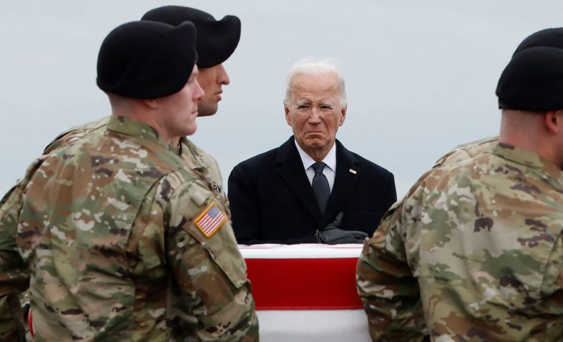 DOVER, DELAWARE - FEBRUARY 02: U.S. President Joe Biden places his hand over his heart as a U.S. Army carry team moves a flagged draped transfer case containing the remains of Army Sgt. Breonna Moffett during a dignified transfer at Dover Air Force Base on February 02, 2024 in Dover, Delaware. U.S. Army Sgt. William Rivers, Sgt. Breonna Moffett, Sgt. Kennedy Sanders were killed in addition to 40 other troops were injured during a drone strike in Jordan. (Photo by Kevin Dietsch/Getty Images)