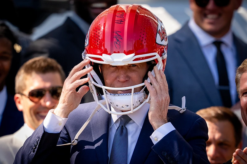 President Biden Hosts Super Bowl Champion Kansas City Chiefs At White House
WASHINGTON, DC - MAY 31: U.S. President Joe Biden puts on a team helmet presented to him by the NFL Kansas City Chiefs on the South Lawn of the White House on May 31, 2024 in Washington, DC. President Biden hosted the Chiefs to honor their 2024 Super Bowl win. (Photo by Andrew Harnik/Getty Images)