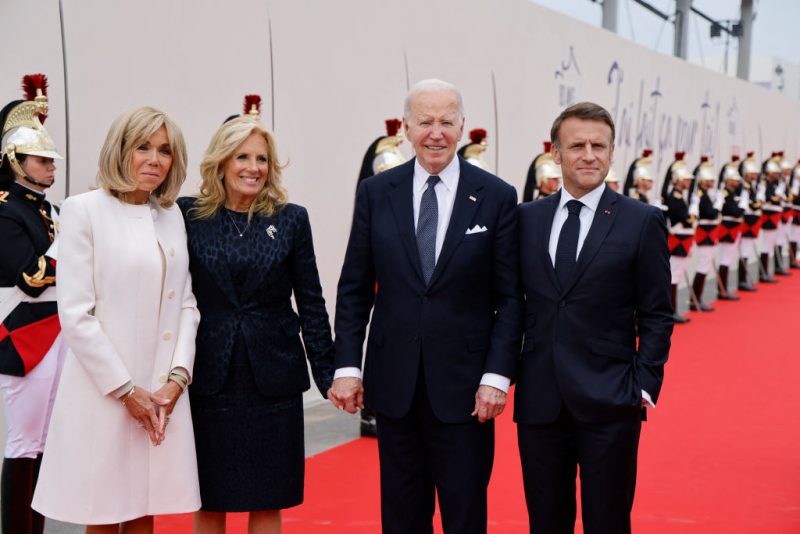 France's President Emmanuel Macron (R), French President's wife Brigitte Macron (L) pose with US President Joe Biden and US First Lady Jill Biden upon their arrival to attend the International commemorative ceremony at Omaha Beach marking the 80th anniversary of the World War II "D-Day" Allied landings in Normandy, in Saint-Laurent-sur-Mer, in northwestern France, on June 6, 2024. The D-Day ceremonies on June 6 this year mark the 80th anniversary since the launch of 'Operation Overlord', a vast military operation by Allied forces in Normandy, which turned the tide of World War II, eventually leading to the liberation of occupied France and the end of the war against Nazi Germany. (Photo by Ludovic MARIN / AFP) (Photo by LUDOVIC MARIN/AFP via Getty Images)