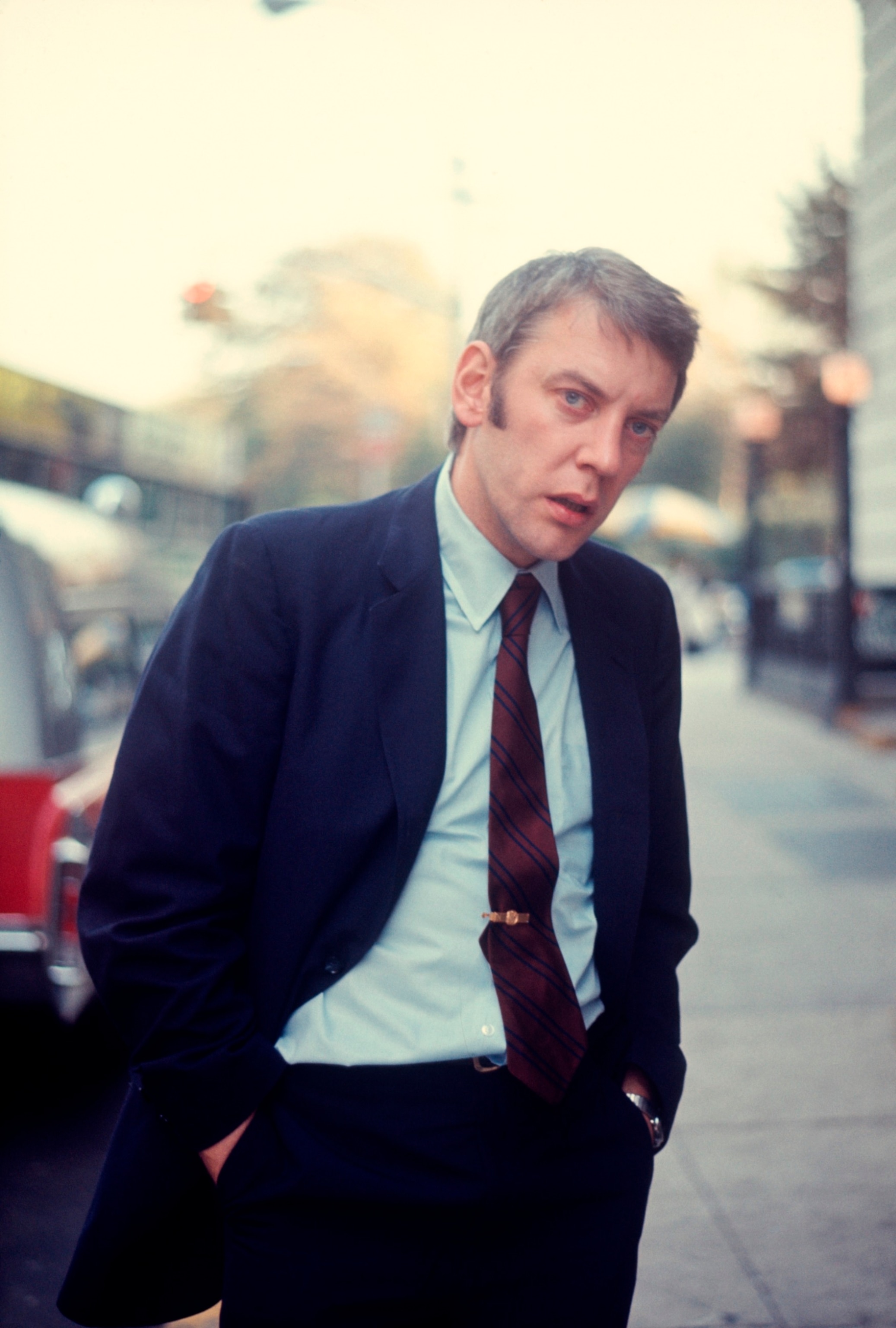 PHOTO: Donald Sutherland in a suit and tie on the street; circa 1970; New York.