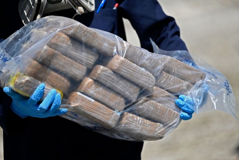 A member of the Attorney General's office carries a bag with packages of cocaine to be incinerated in Ilopango, El Salvador, on August 10, 2021. - 1,370 kilos of drug were seized from six foreigners 490 nautical miles south of Punta Remedios in Acajutla, Sonsonate, on July 31, 2021. (Photo by MARVIN RECINOS / AFP) (Photo by MARVIN RECINOS/AFP via Getty Images)