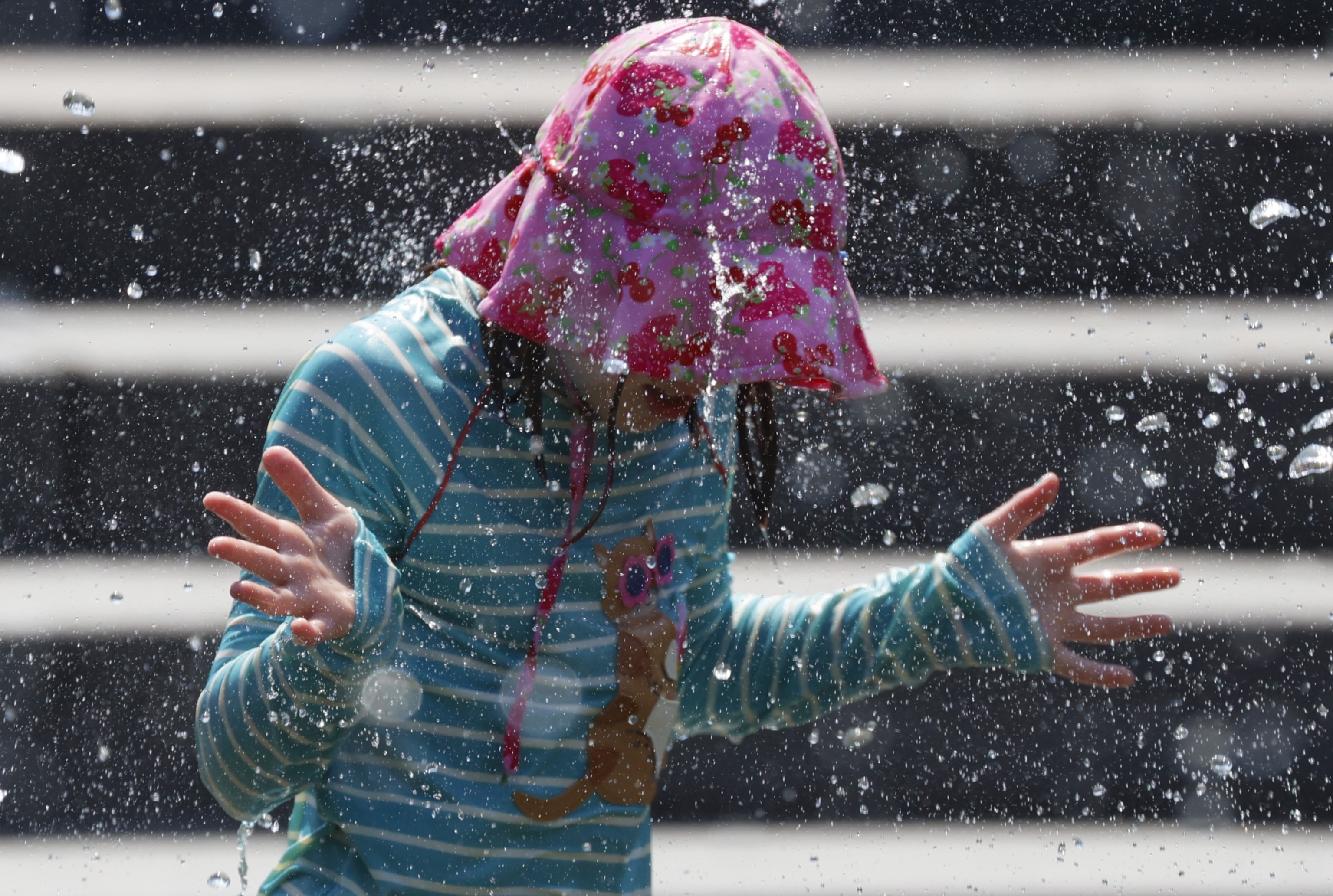 PHOTO: A child cools off in the fountain at Washington Square Park in New York City on June 19, 2024.