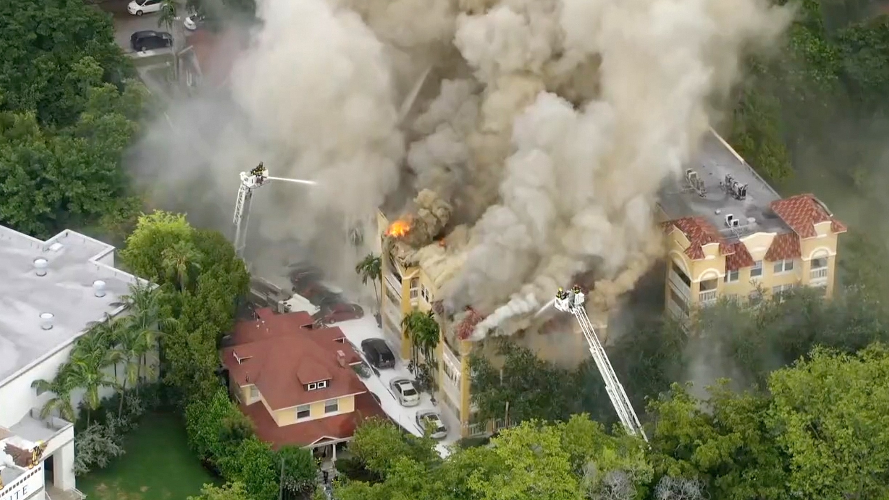 PHOTO: Firefighters work to extinguish a fire at a four-story apartment building in the city of Miami, June 10, 2024.