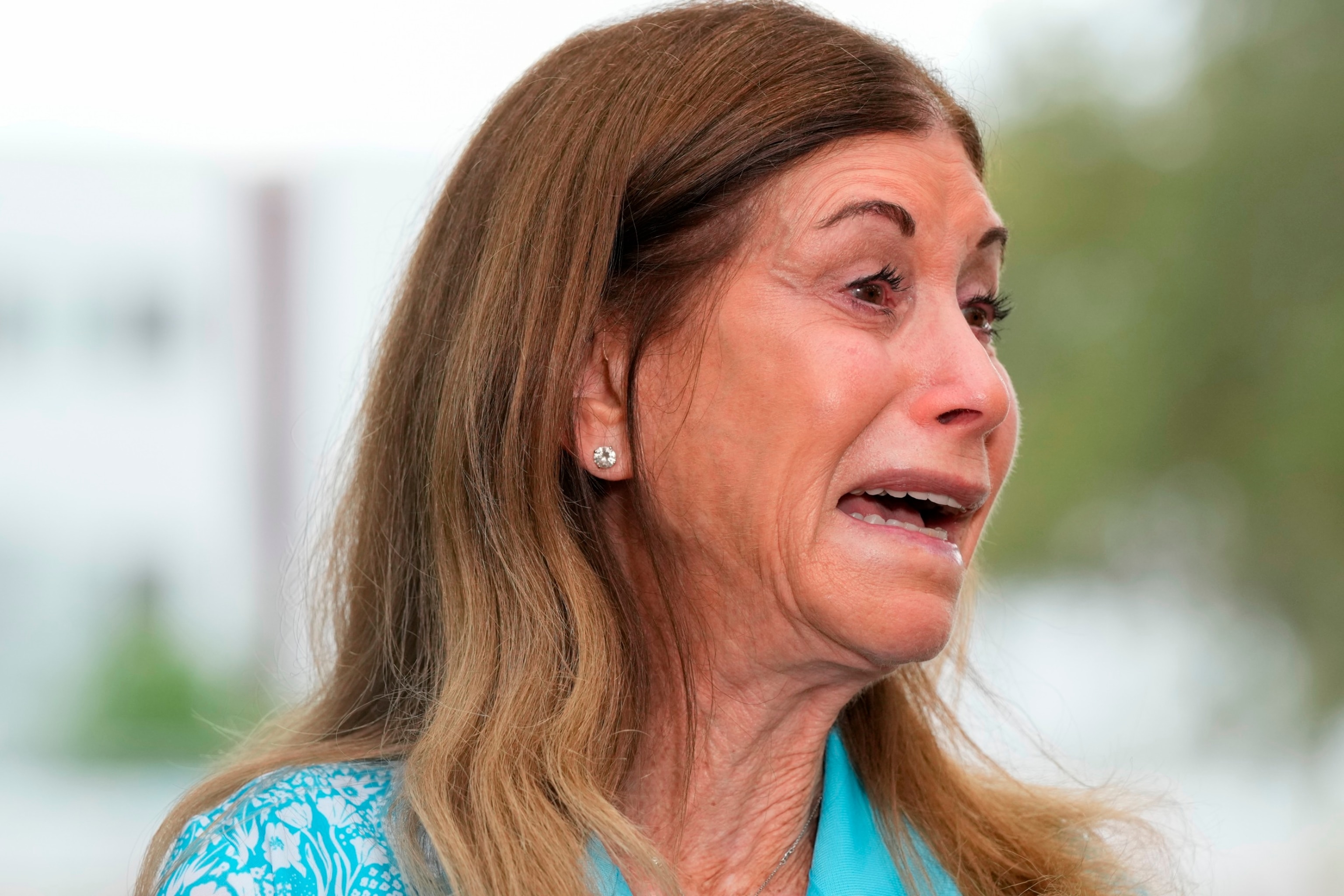 PHOTO: Linda Beigel Schulman is overcome with emotion as she talks to journalists about visiting the scene where her son and 16 others were killed in 2018 at Marjory Stoneman Douglas High School in Parkland, Fla., July 5, 2023.