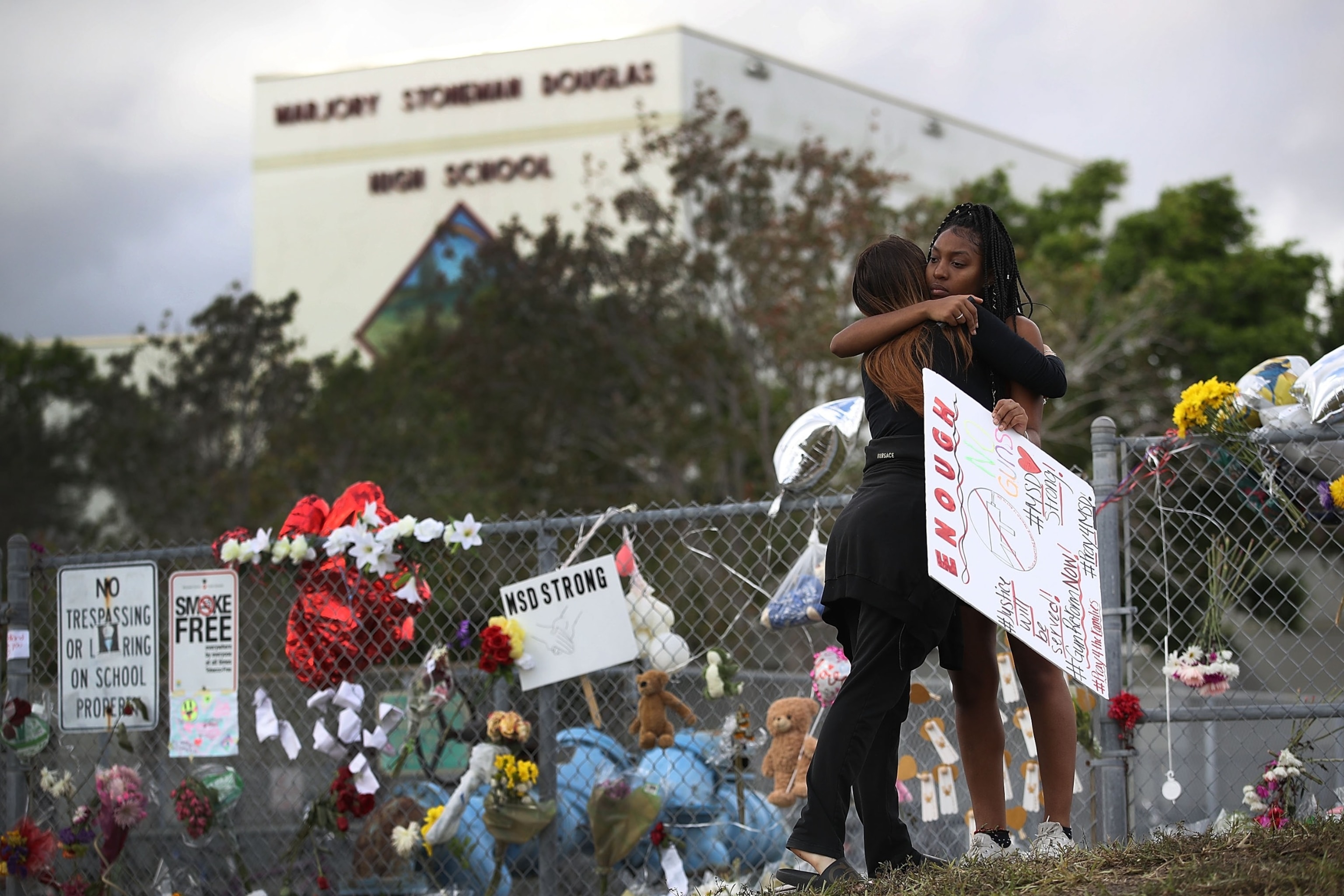 PHOTO: Tyra Heman (R) a senior at Marjory Stoneman Douglas High School, is hugged by Rachael Buto in front of the school where 17 people that were killed on February 14, Feb. 19, 2018, in Parkland, Fla.