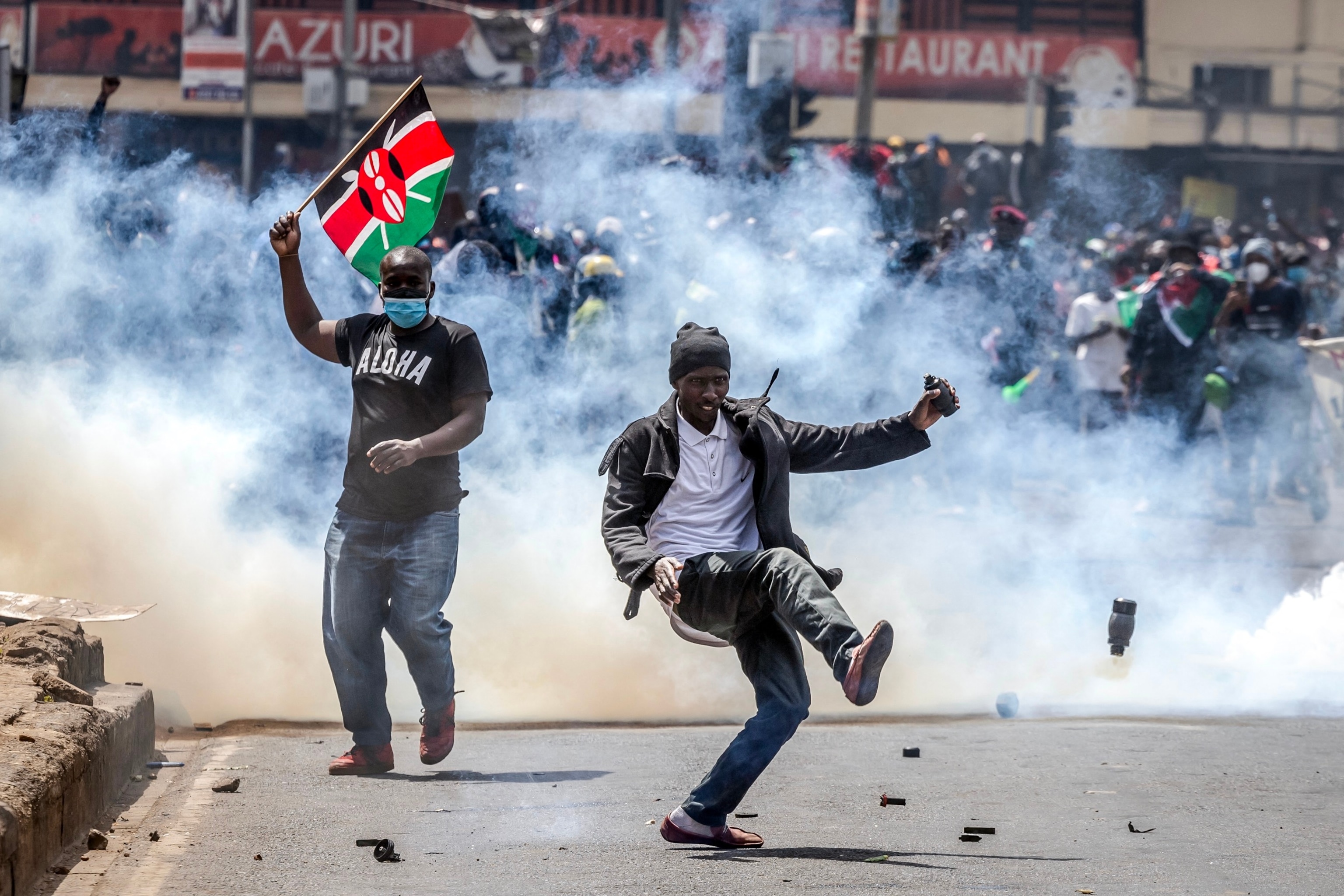 PHOTO: A protester kicks a tear gas canister while demonstrating during a nationwide strike to protest against tax hikes and the Finance Bill 2024 in downtown Nairobi, on June 25, 2024. 