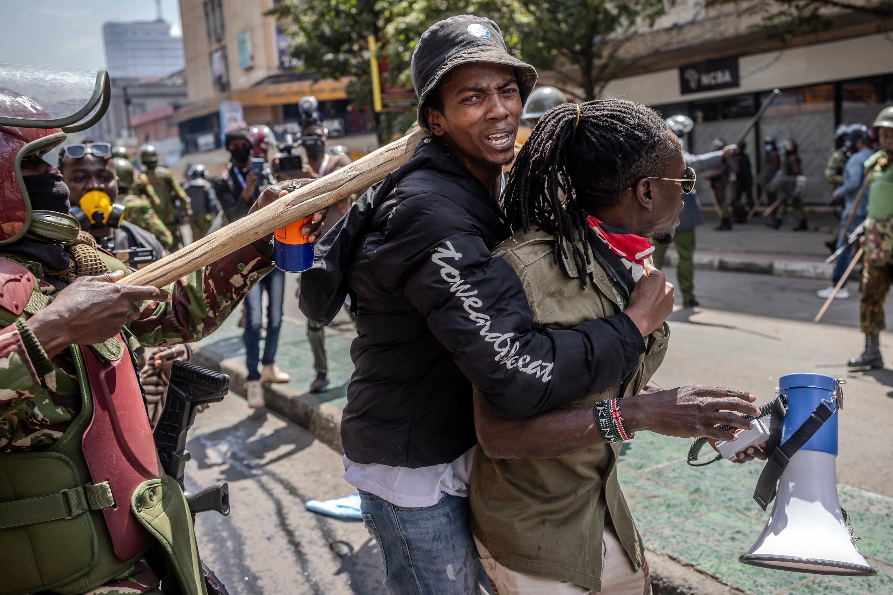 PHOTO: Protesters react after being pushed by Kenya Police officers while demonstrating during a nationwide strike to protest against tax hikes and the Finance Bill 2024 in downtown Nairobi, on June 25, 2024. 