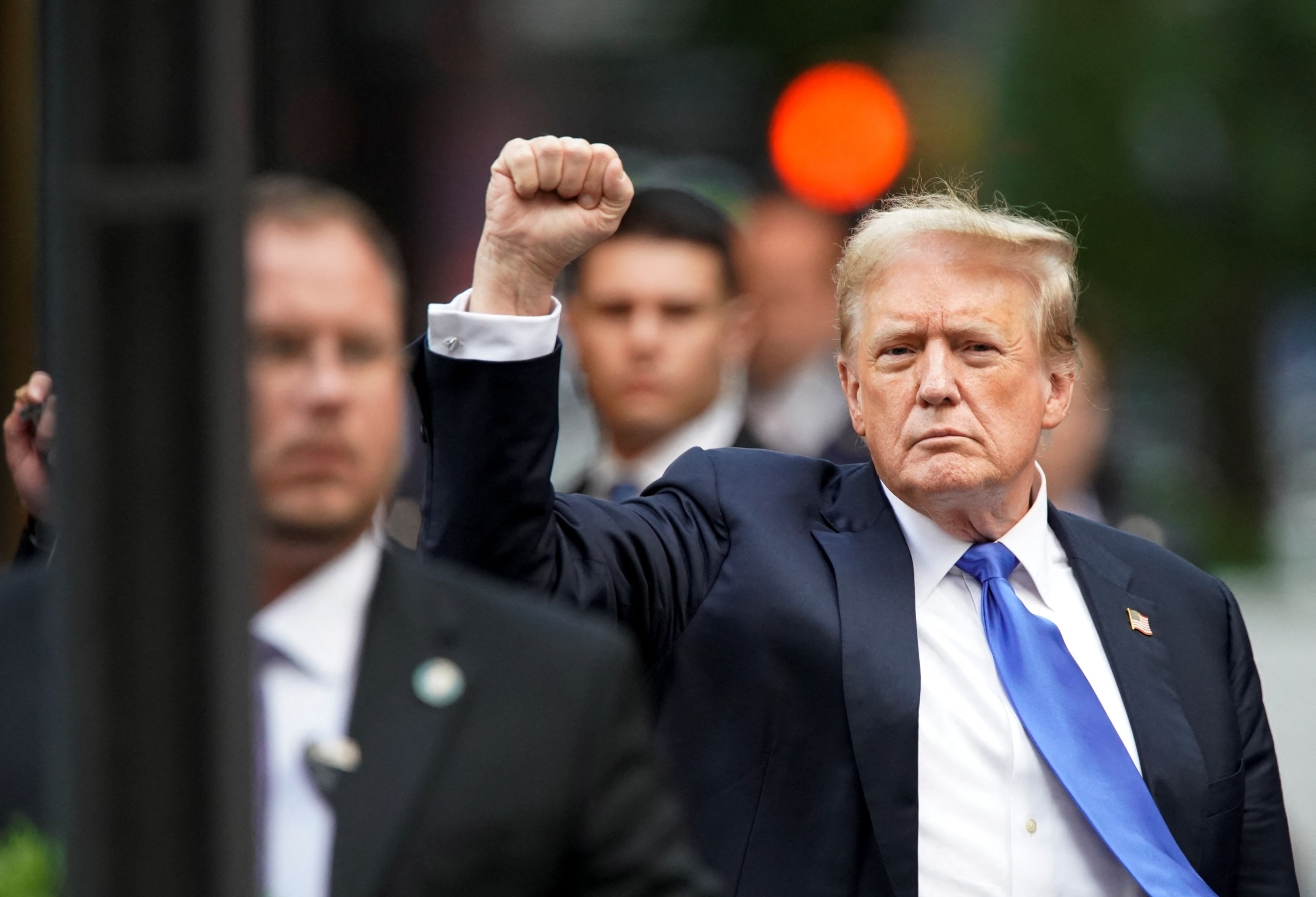 PHOTO: Former President Donald Trump pumps a fist outside Trump Tower after the verdict in his criminal trial over charges that he falsified business records to conceal money paid to silence porn star Stormy Daniels in 2016, in New York, May 30, 2024. 