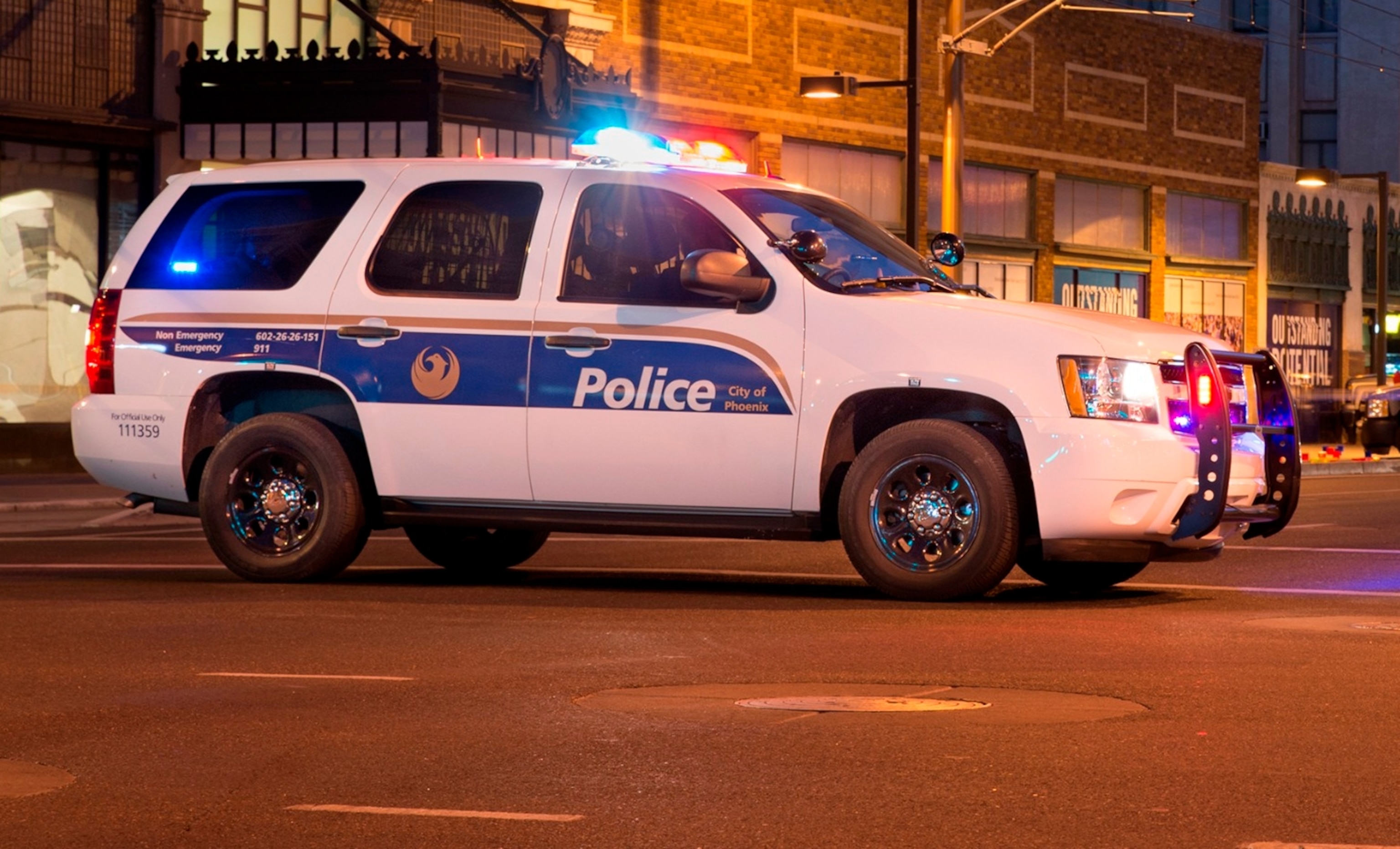 PHOTO: PIn this March 18, 2014, file photo, a police car blocks an avenue in downtown Phoenix.