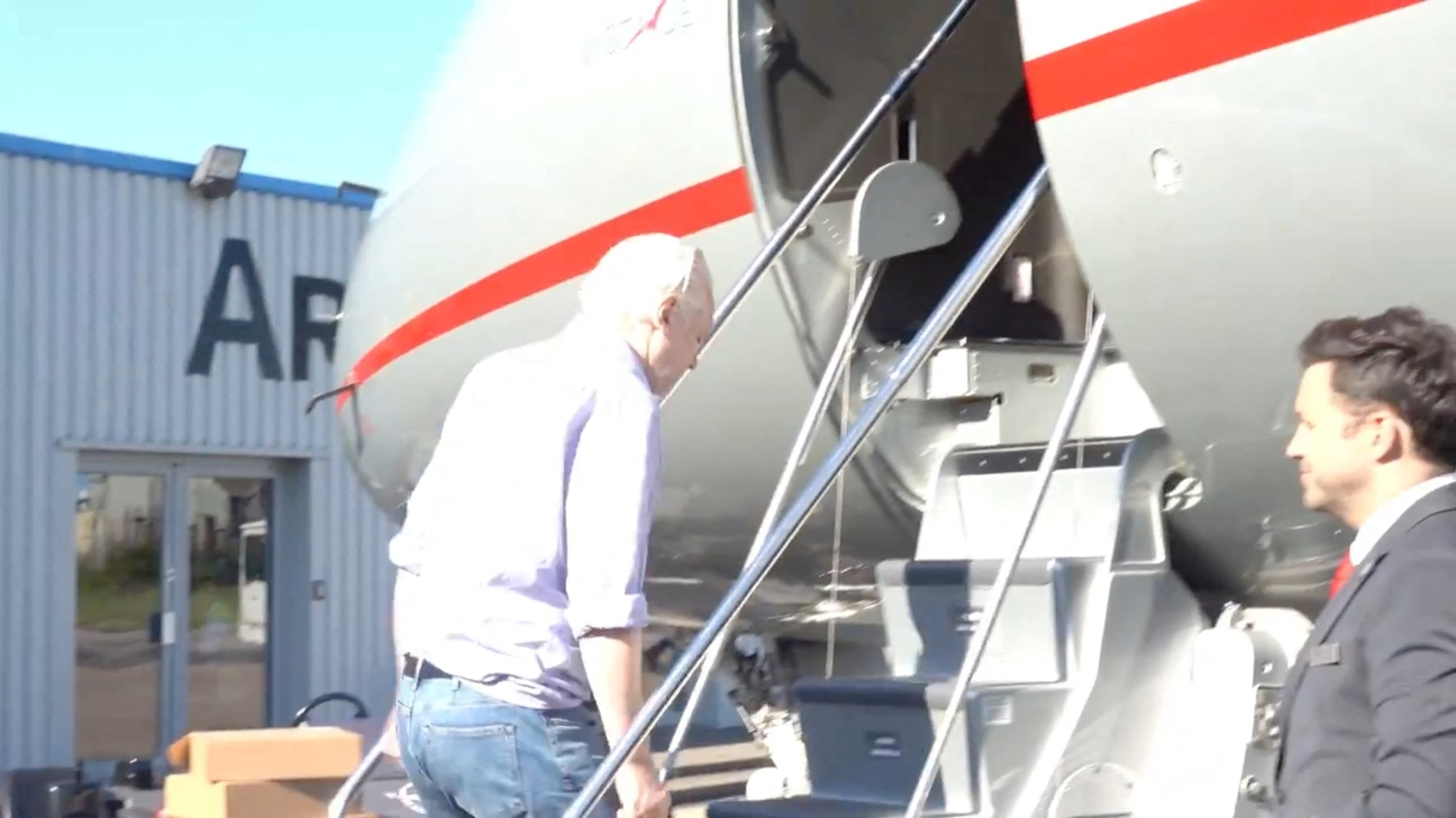 PHOTO: WikiLeaks founder Julian Assange boards a plane at a location given as London, Britain, in this still image from video released June 25, 2024.