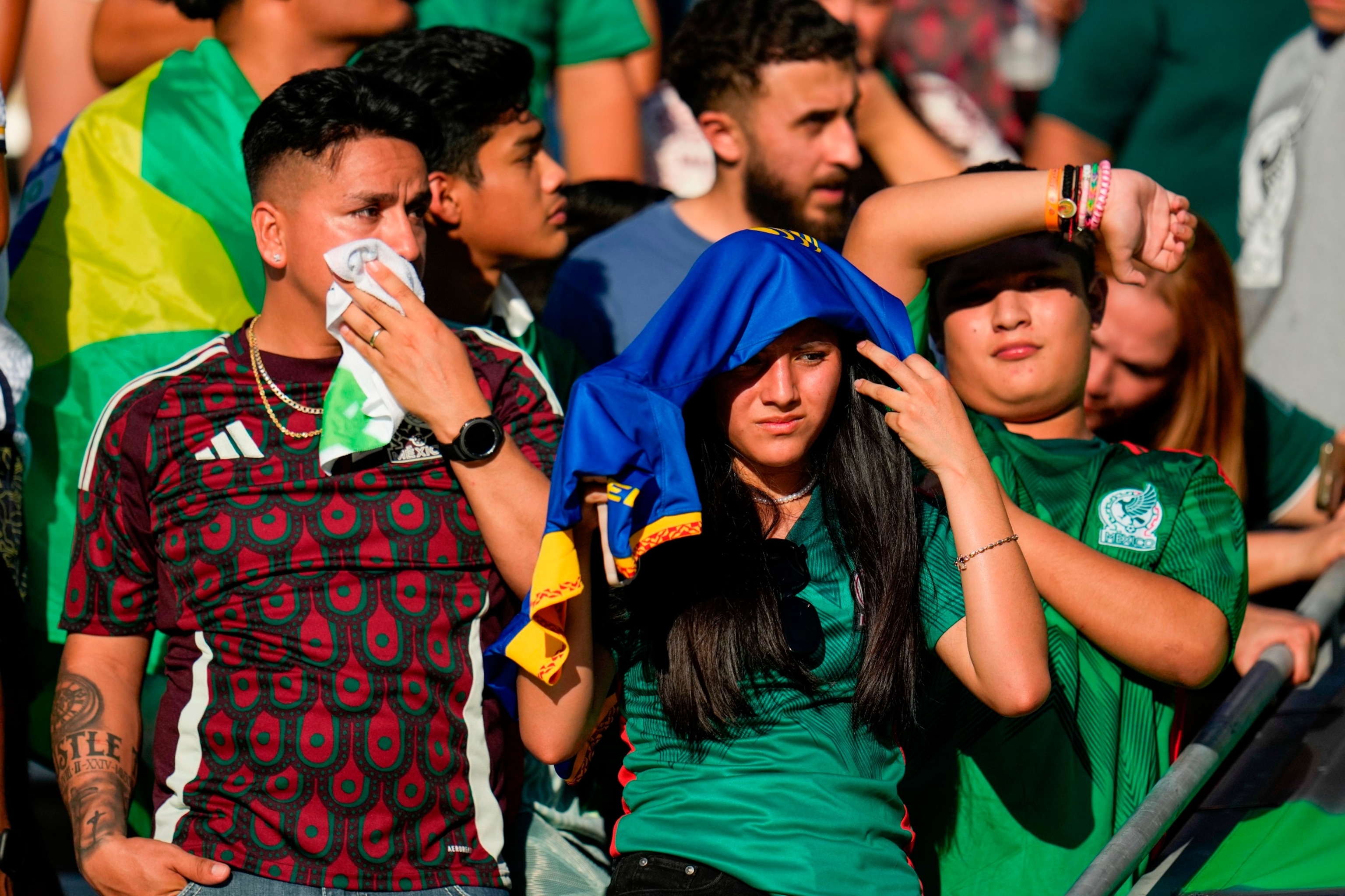 PHOTO: Spectators stand in the heat while waiting to watch players warm up prior to an international soccer friendly between Mexico and Brazil on June 8, 2024, at Texas A&M's Kyle Field in College Station, Texas.