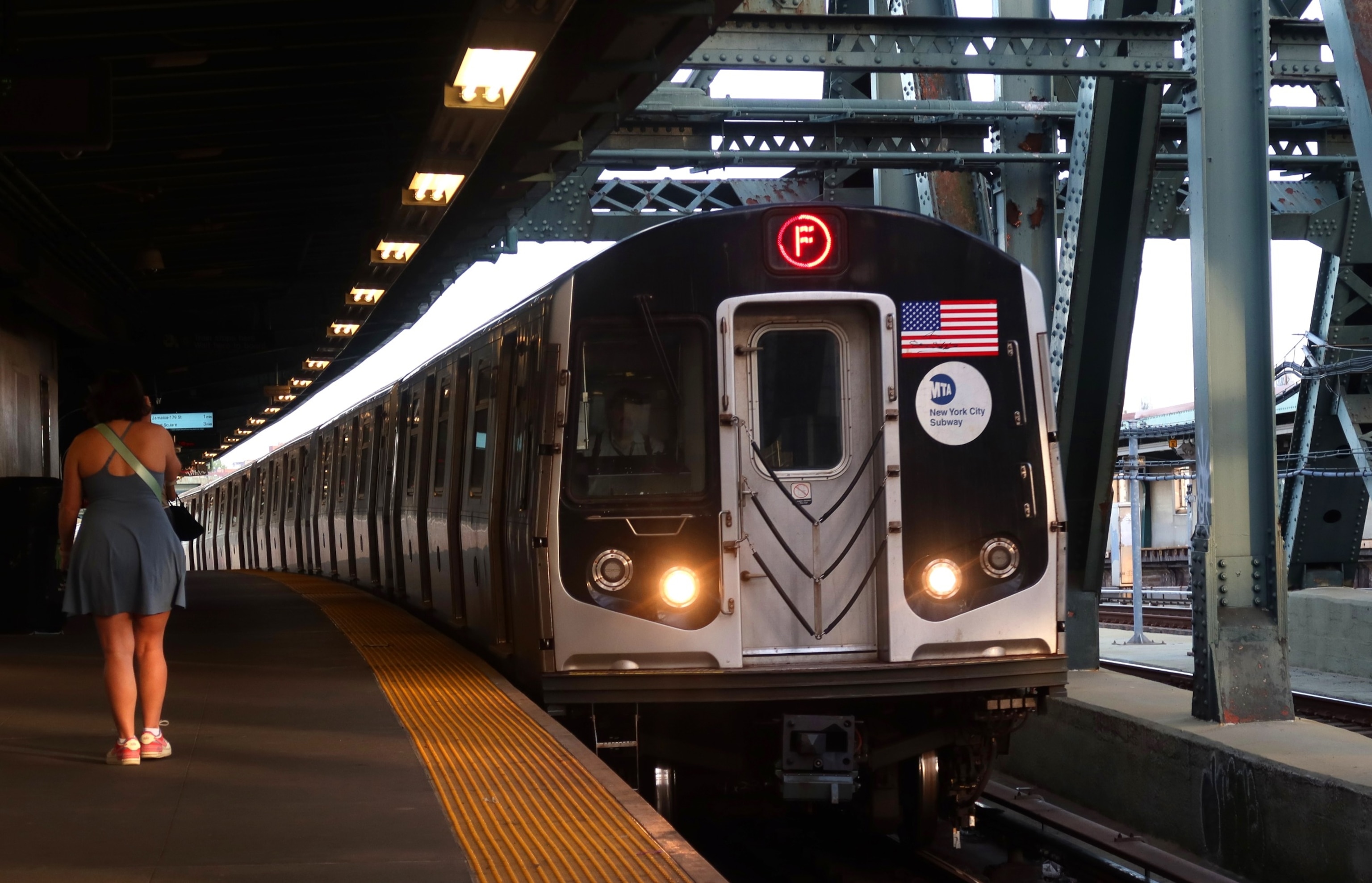 PHOTO: A woman waits to board an F train at the Smith - 9th Street subway station on May 7, 2024, in New York City.