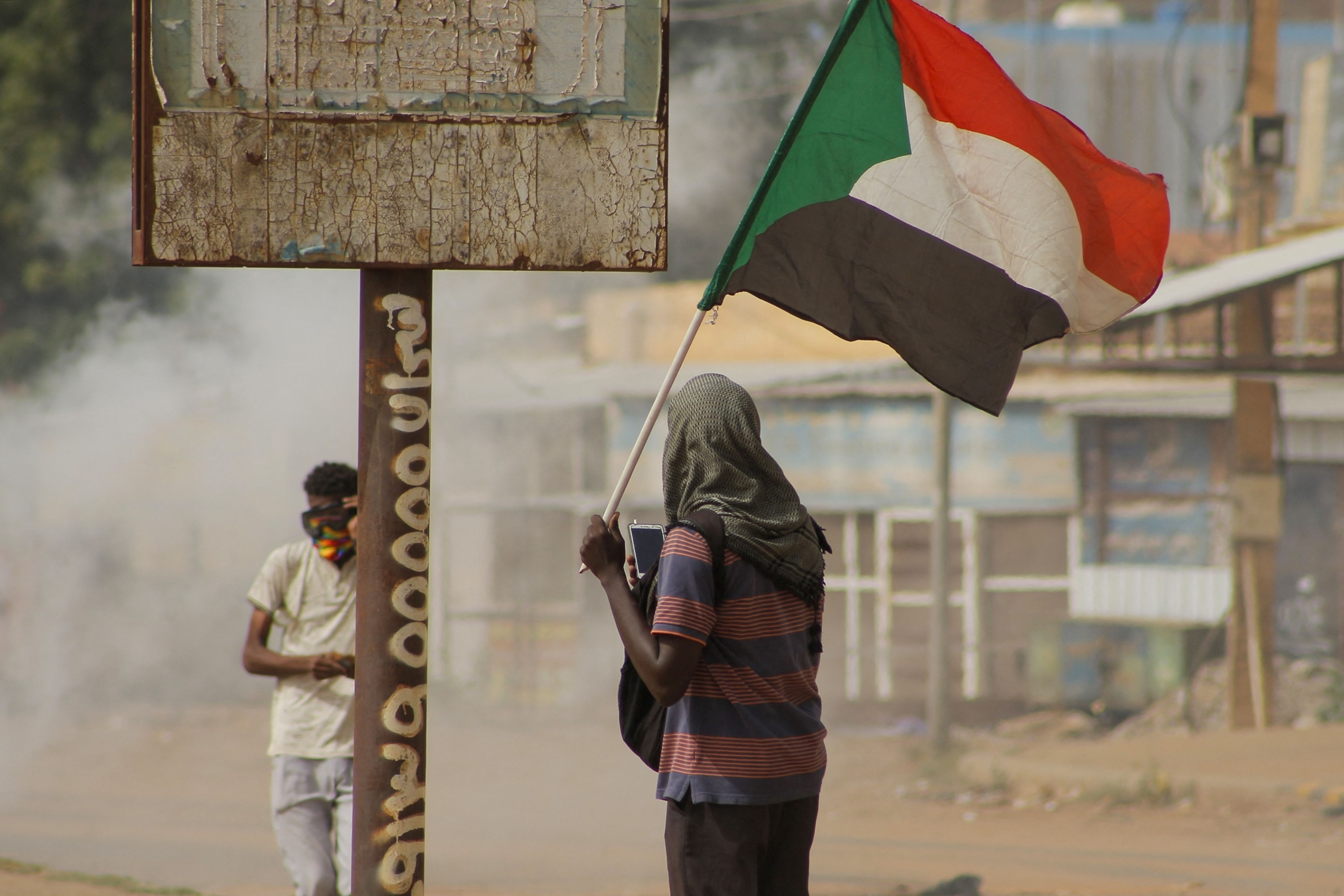 PHOTO: In this Sept. 29, 2022 file photo, a Sudanese demonstrator carries the national flag during a rally to demand the return to civilian rule, in the capital Khartoum.